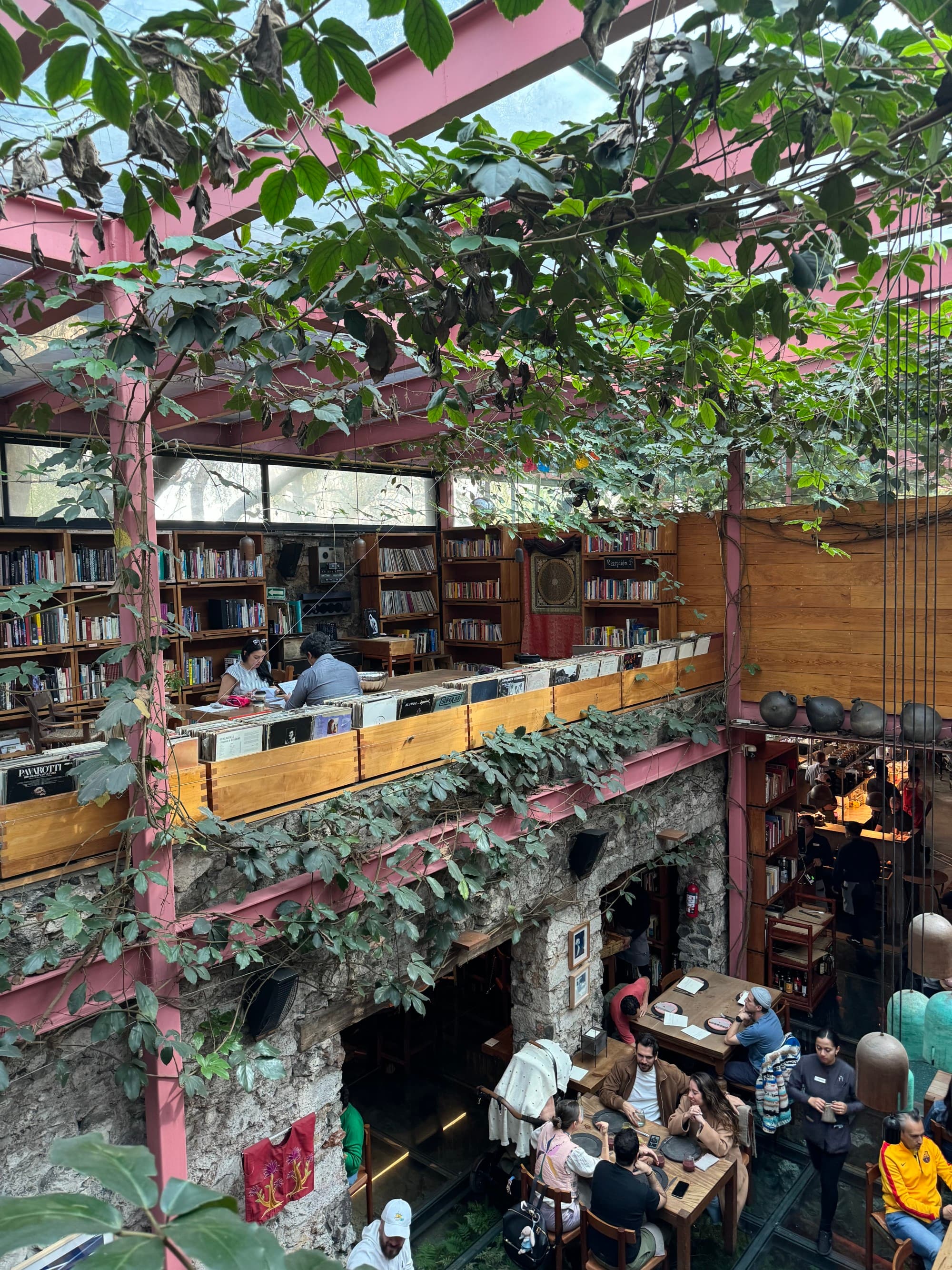 Library on first floor and restaurant at ground floor with people in it.