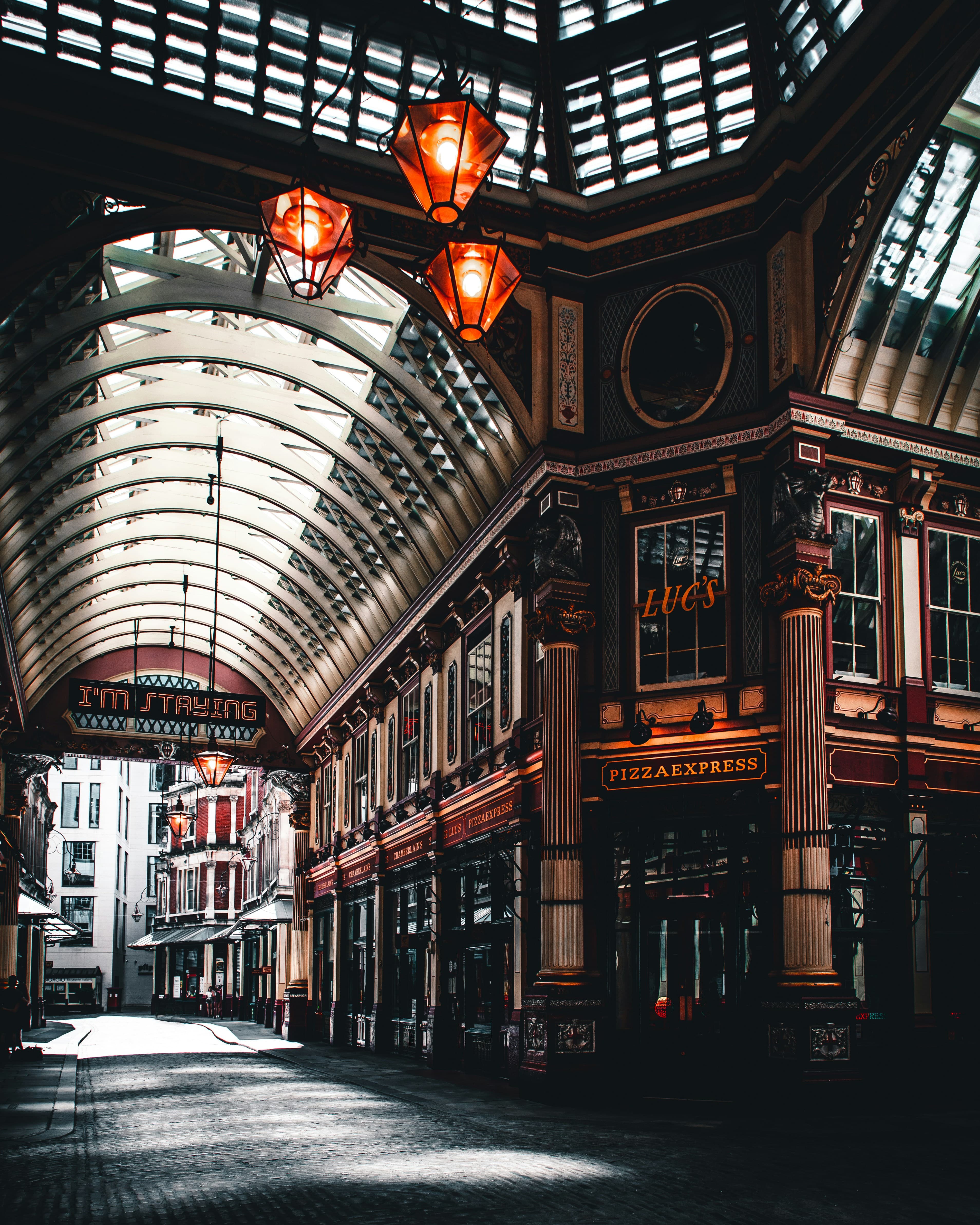 The inside of London marches, with tall ceilings and a curved glass ceiling