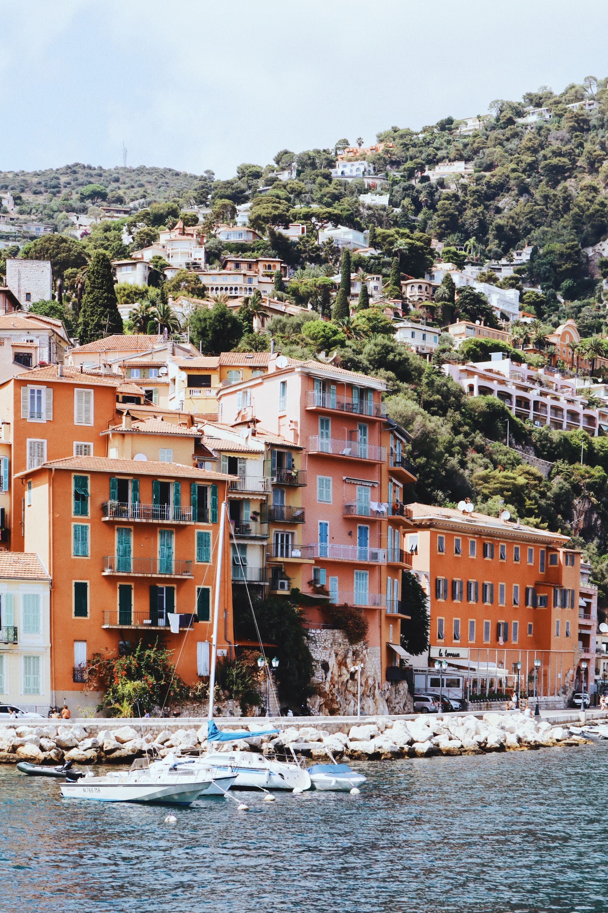 orange buildings on hillside coastal town