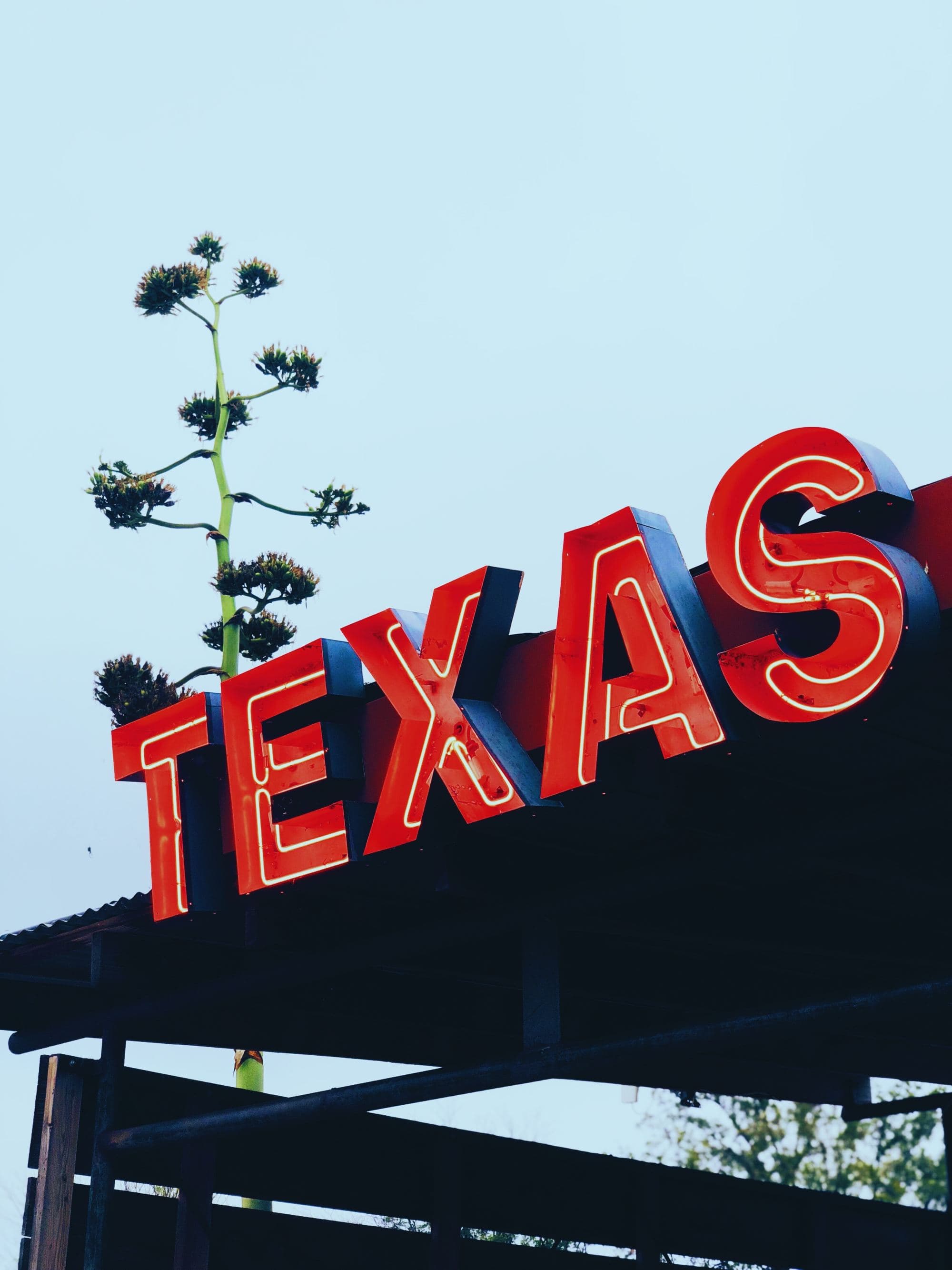 red metal sign that reads "TEXAS"