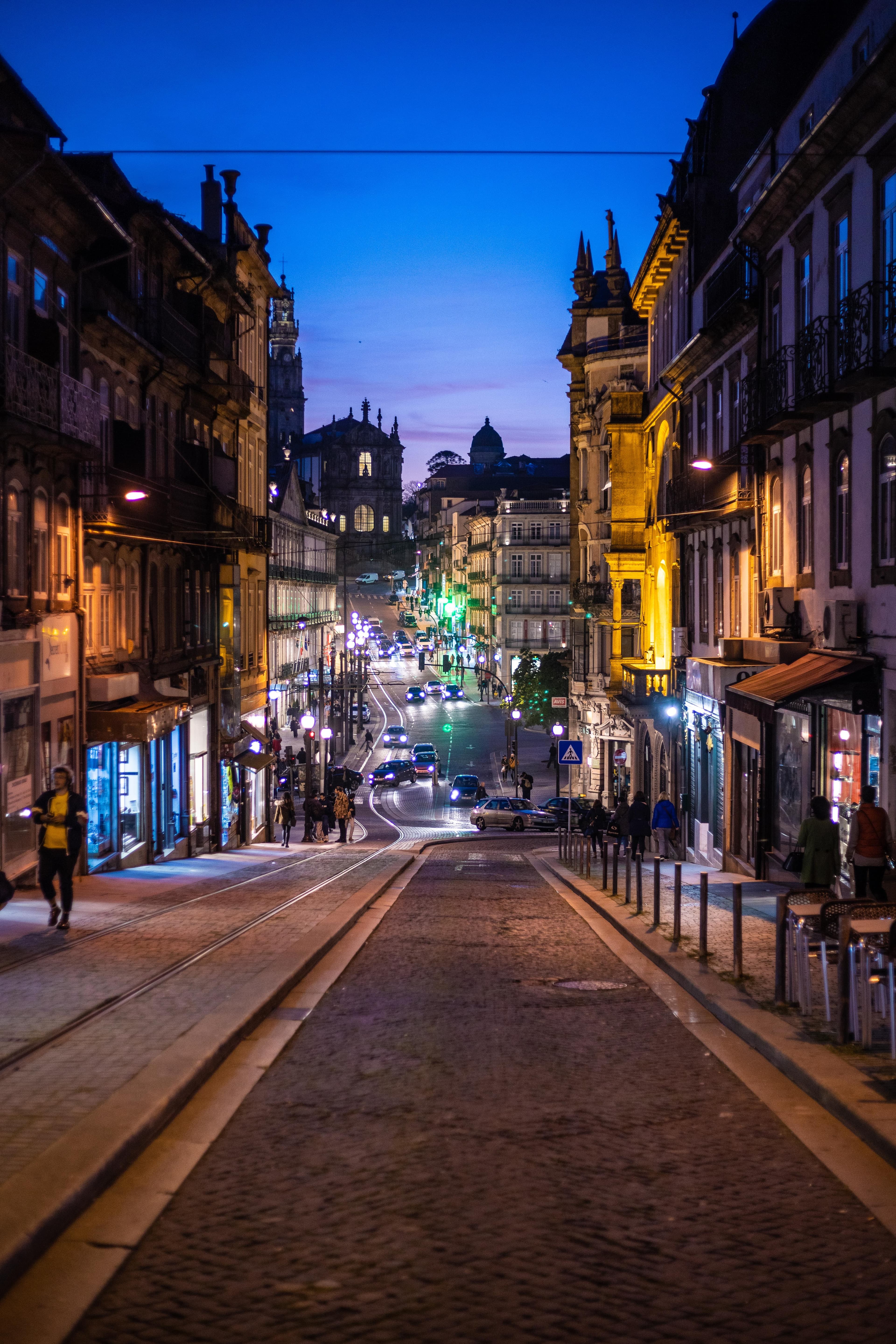 A street on a hill at night in Porto, Portugal.