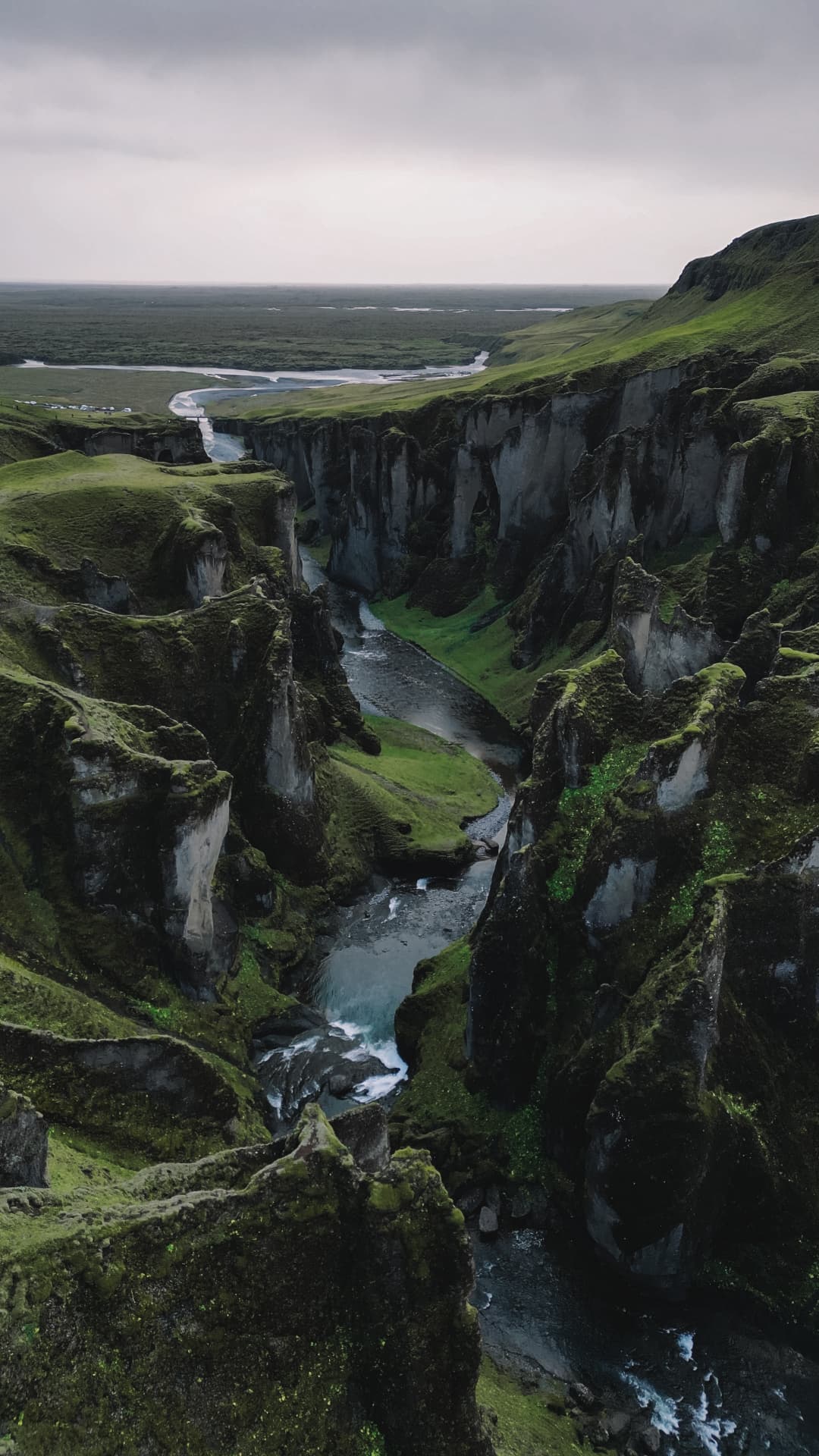 An aerial view of a valley and cliffs at nighttime