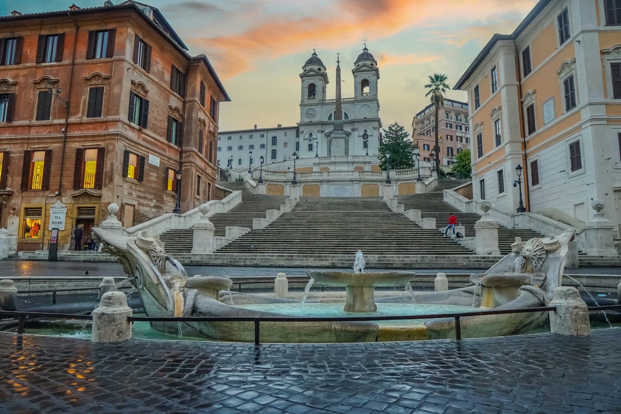 Stairs and a fountain in front of a building.