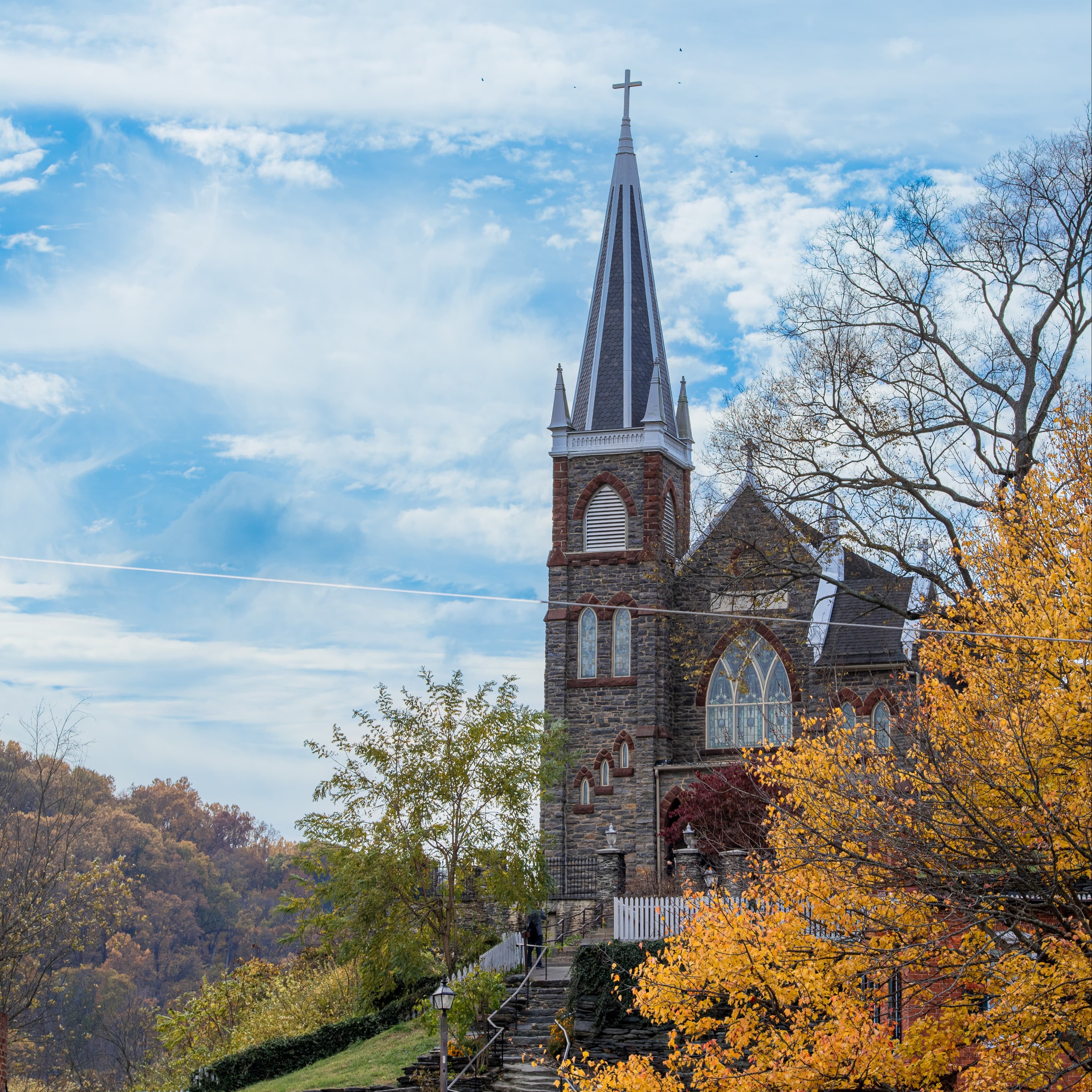 A church with a tree with autumn leaves.