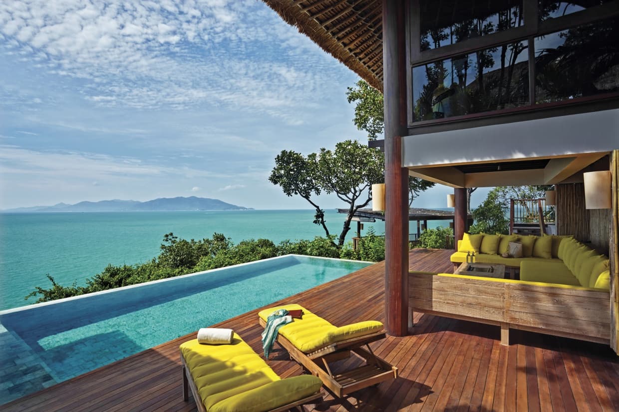 two yellow chairs on deck next to pool during daytime