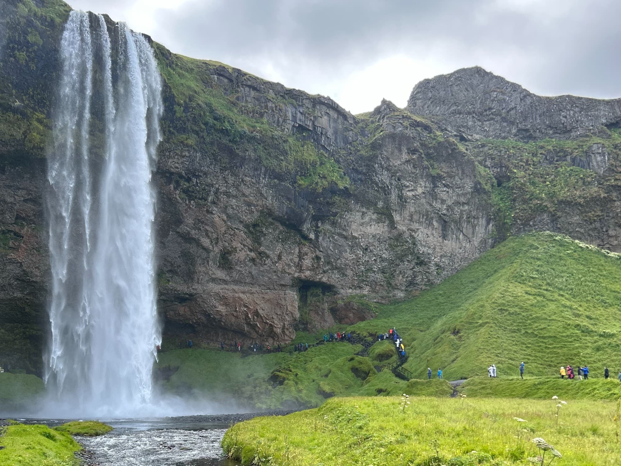 Waterfall with green fields around.