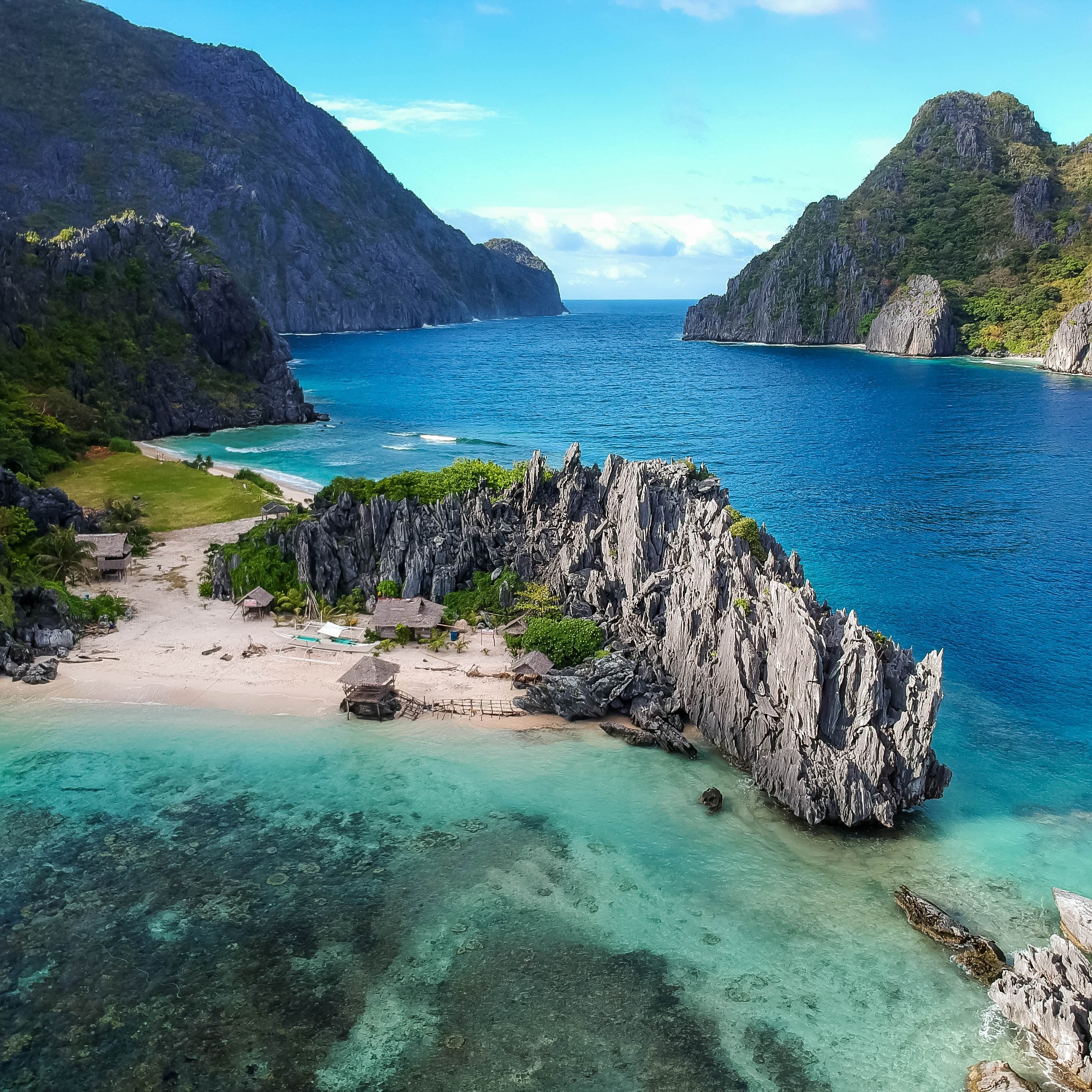 Island with Blue water and rocks at the surrounding