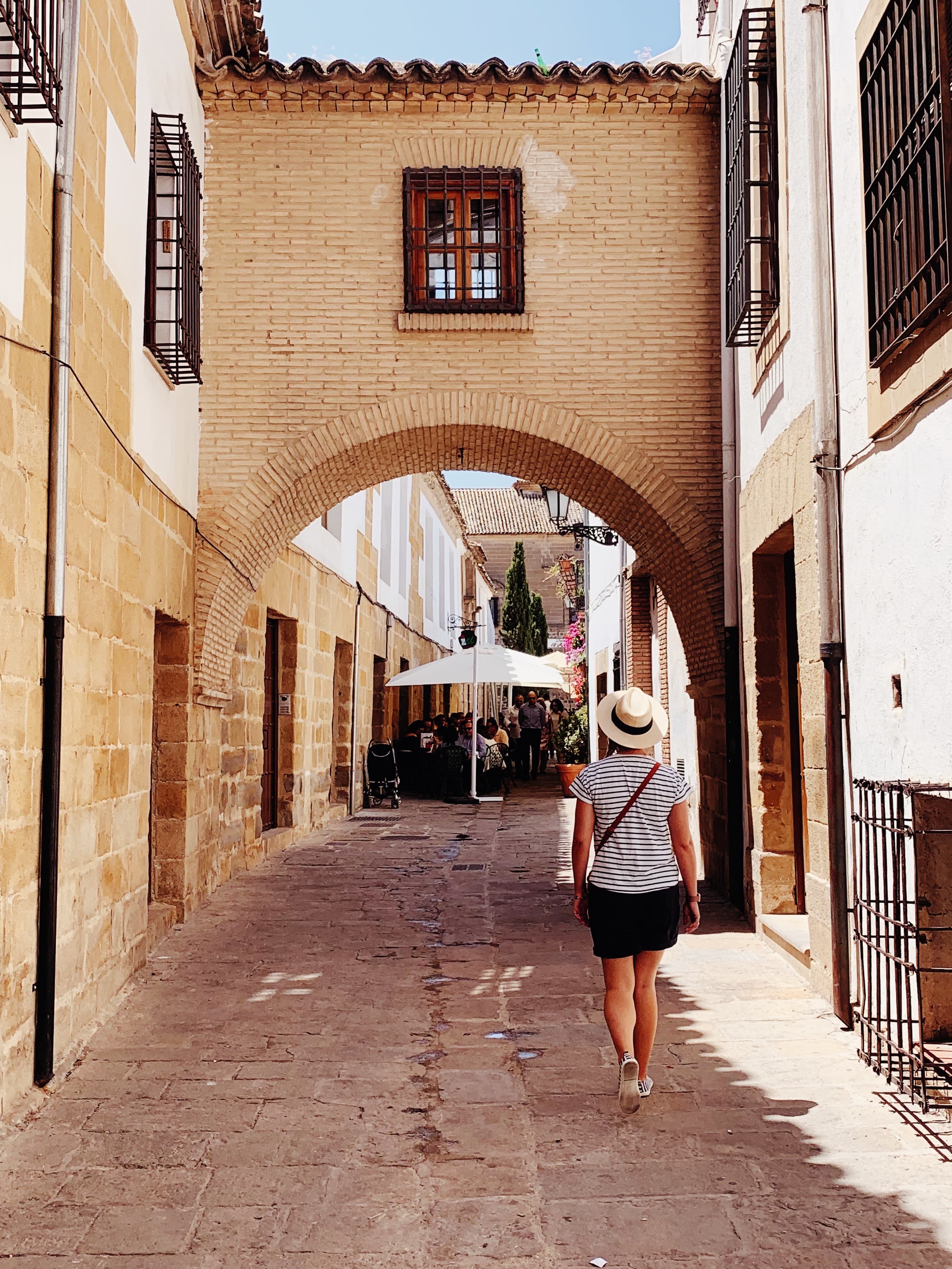 woman walking down alleyway