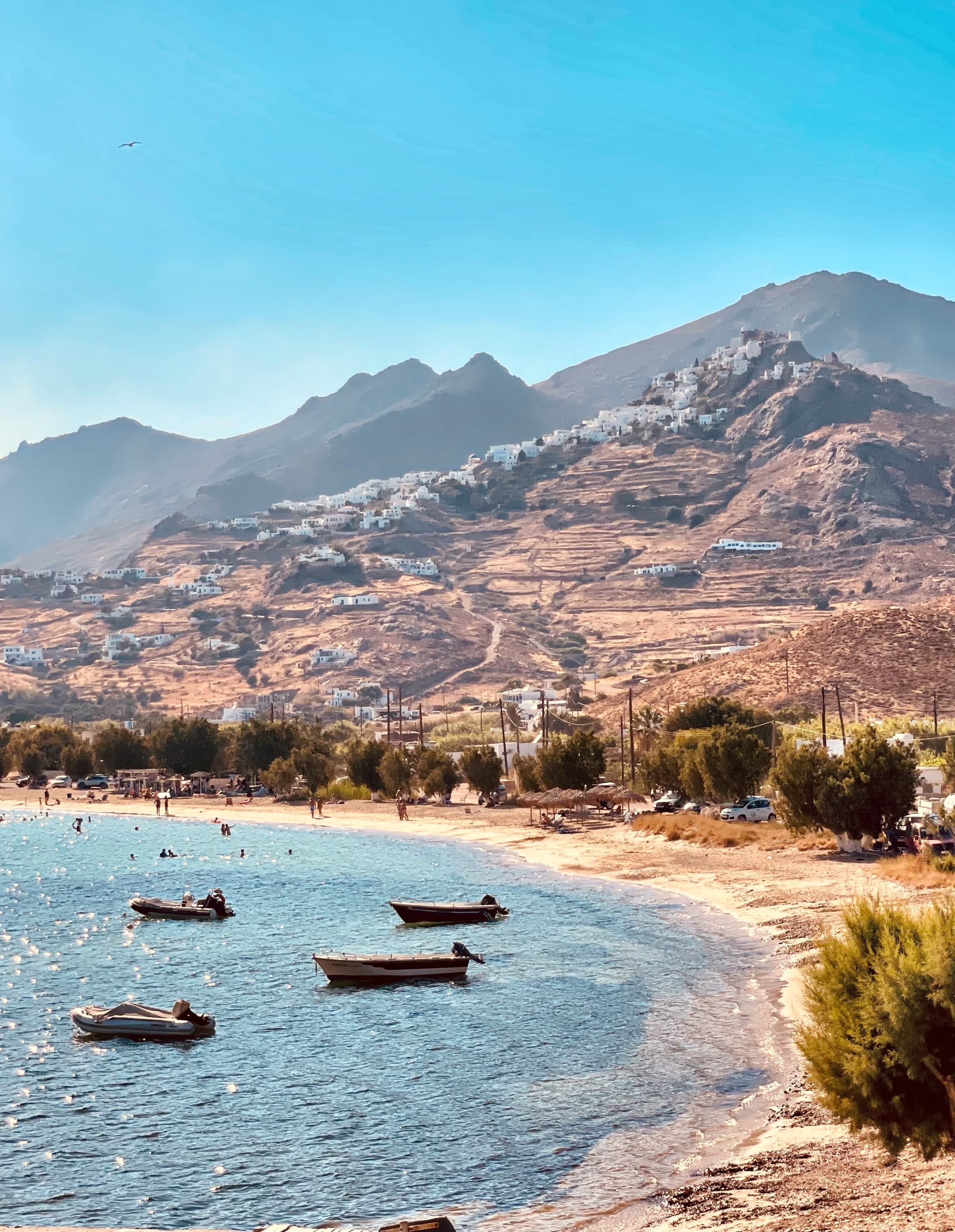 A seashore with boats floating on it.