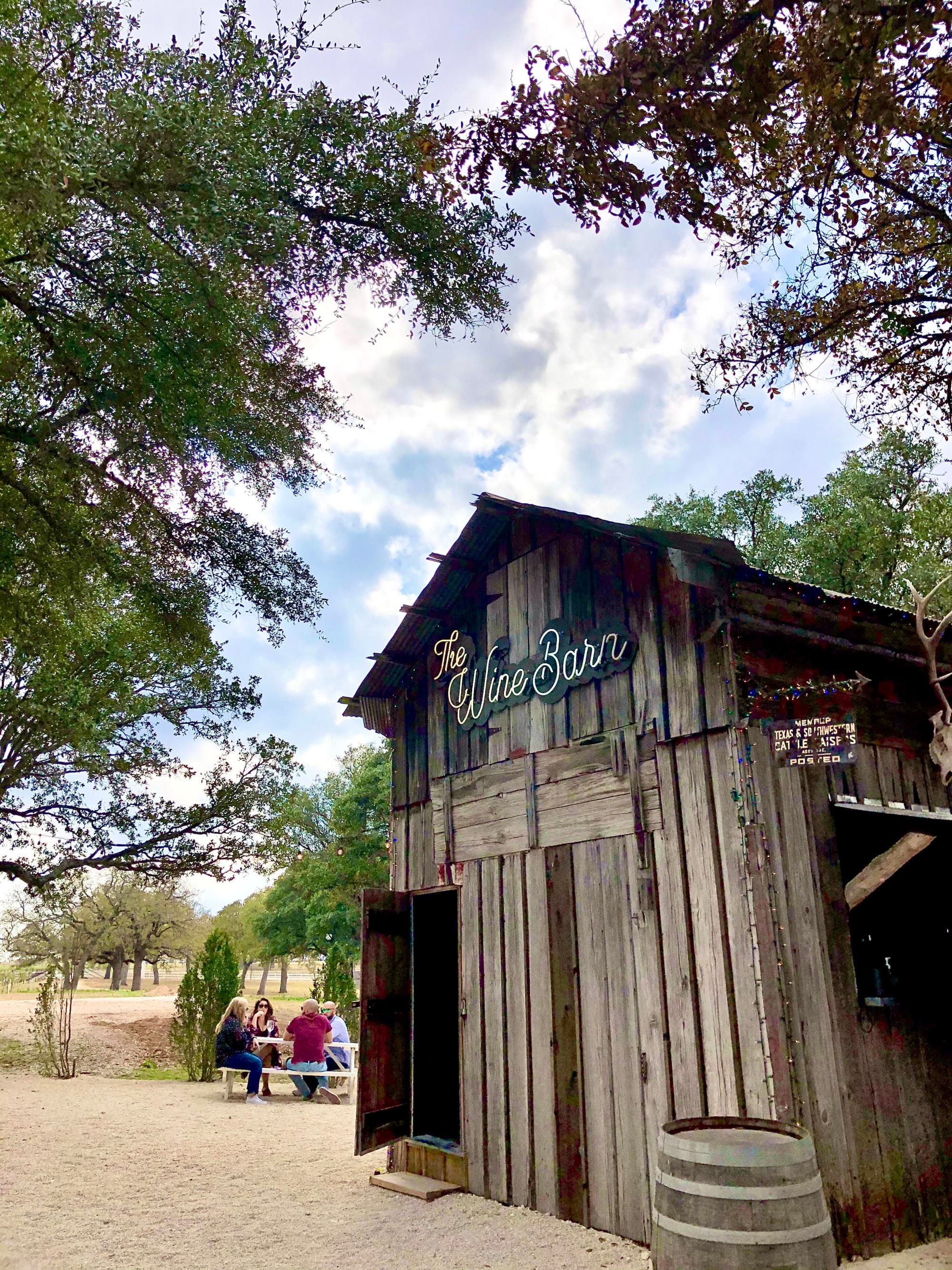 rustic wine barn with a sign that reads "The Wine Barn"