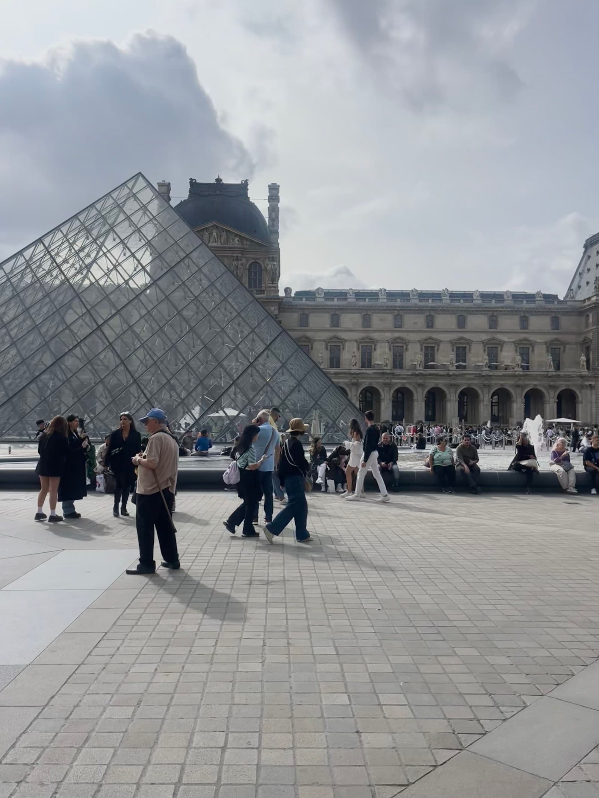 A triangular structure with people walking around.