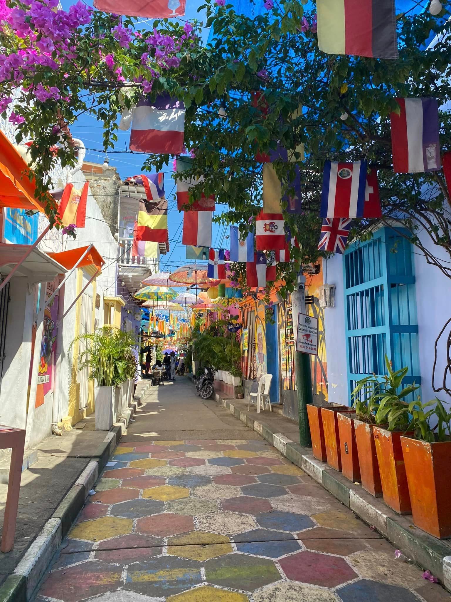 A colorful street with hanging flags.