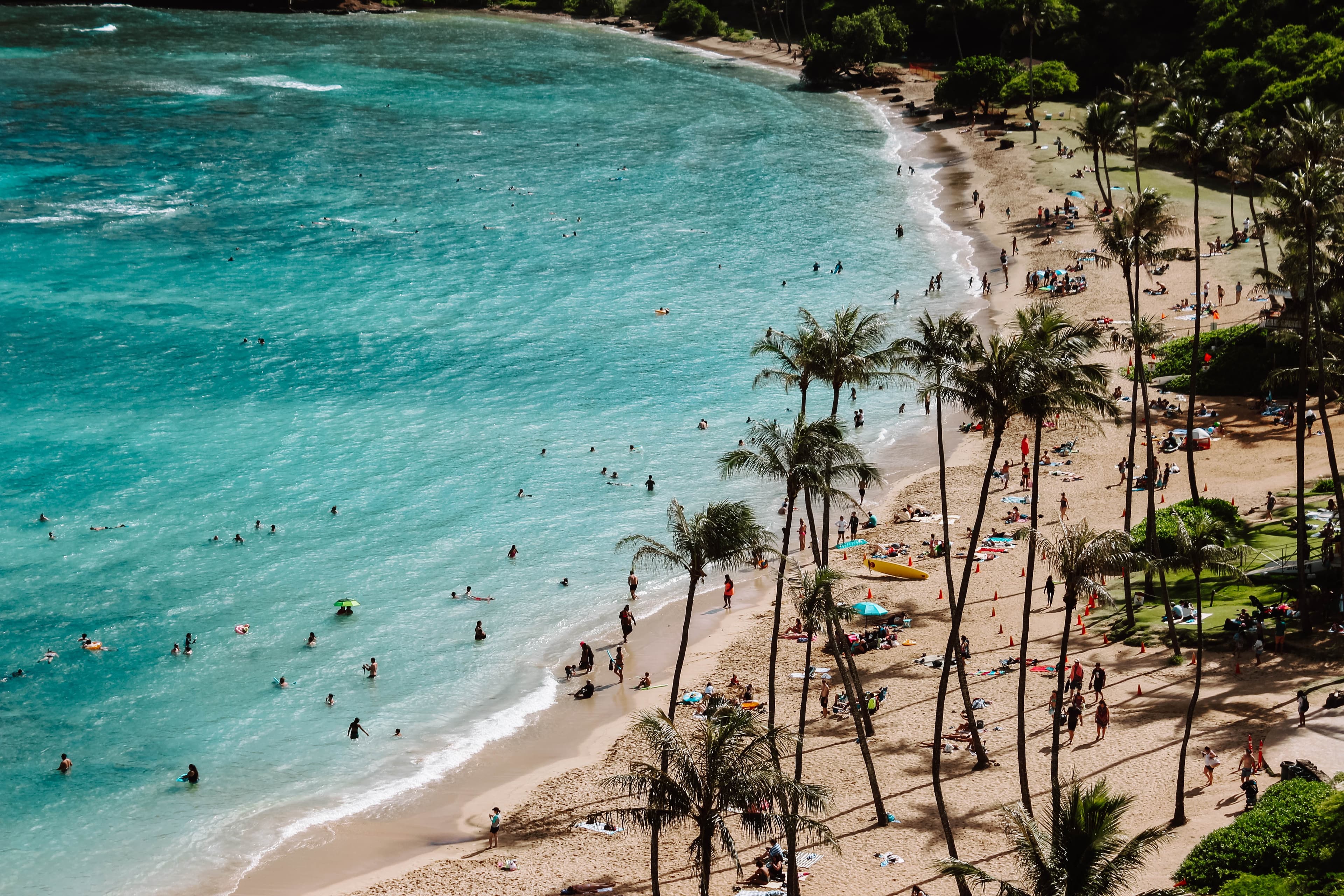 A beautiful beach with people in Oahu, Hawaii.