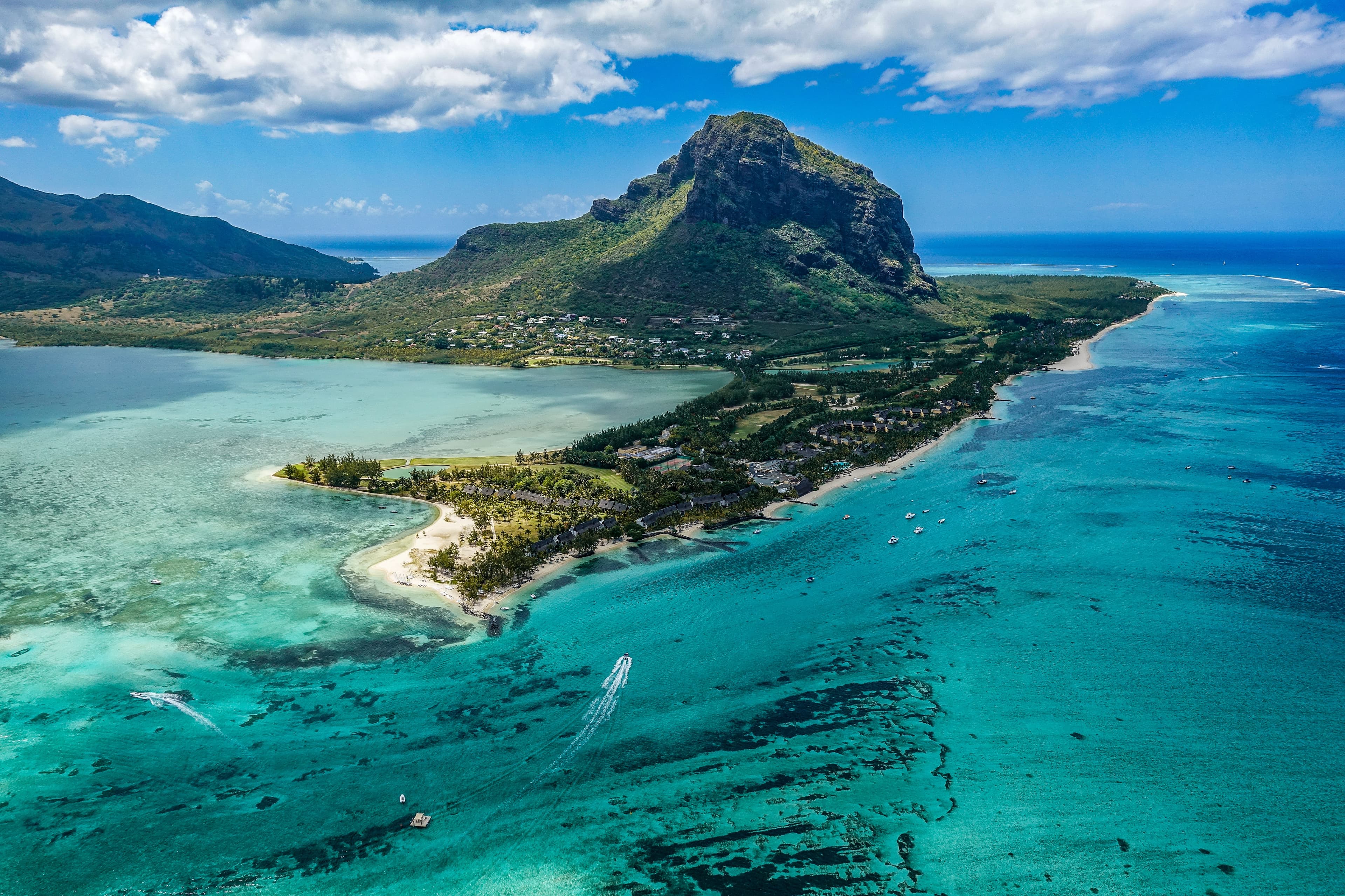 aerial view of island surrounded by blue water during daytime