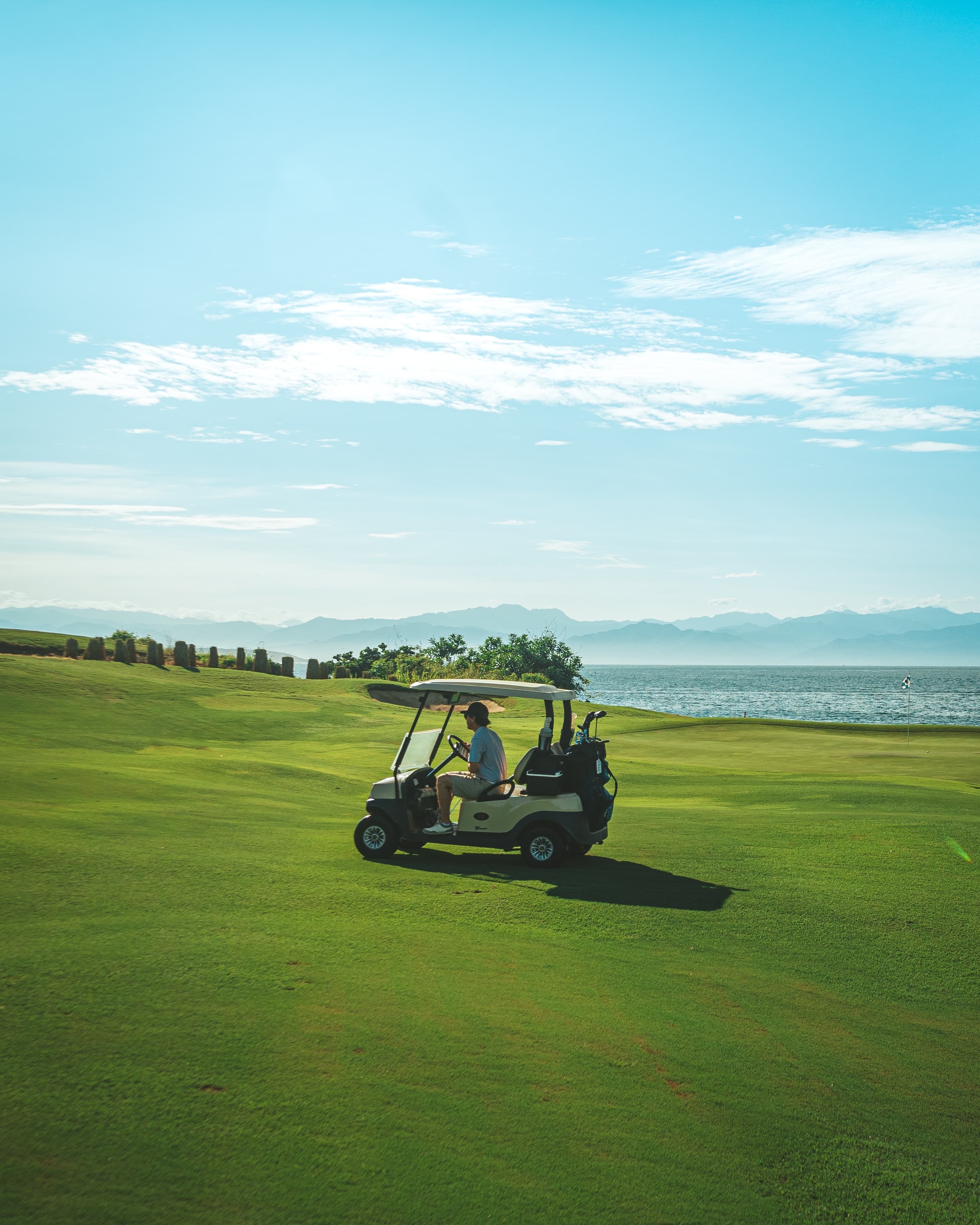 A golf cart on a green golf course in Punta Mita.