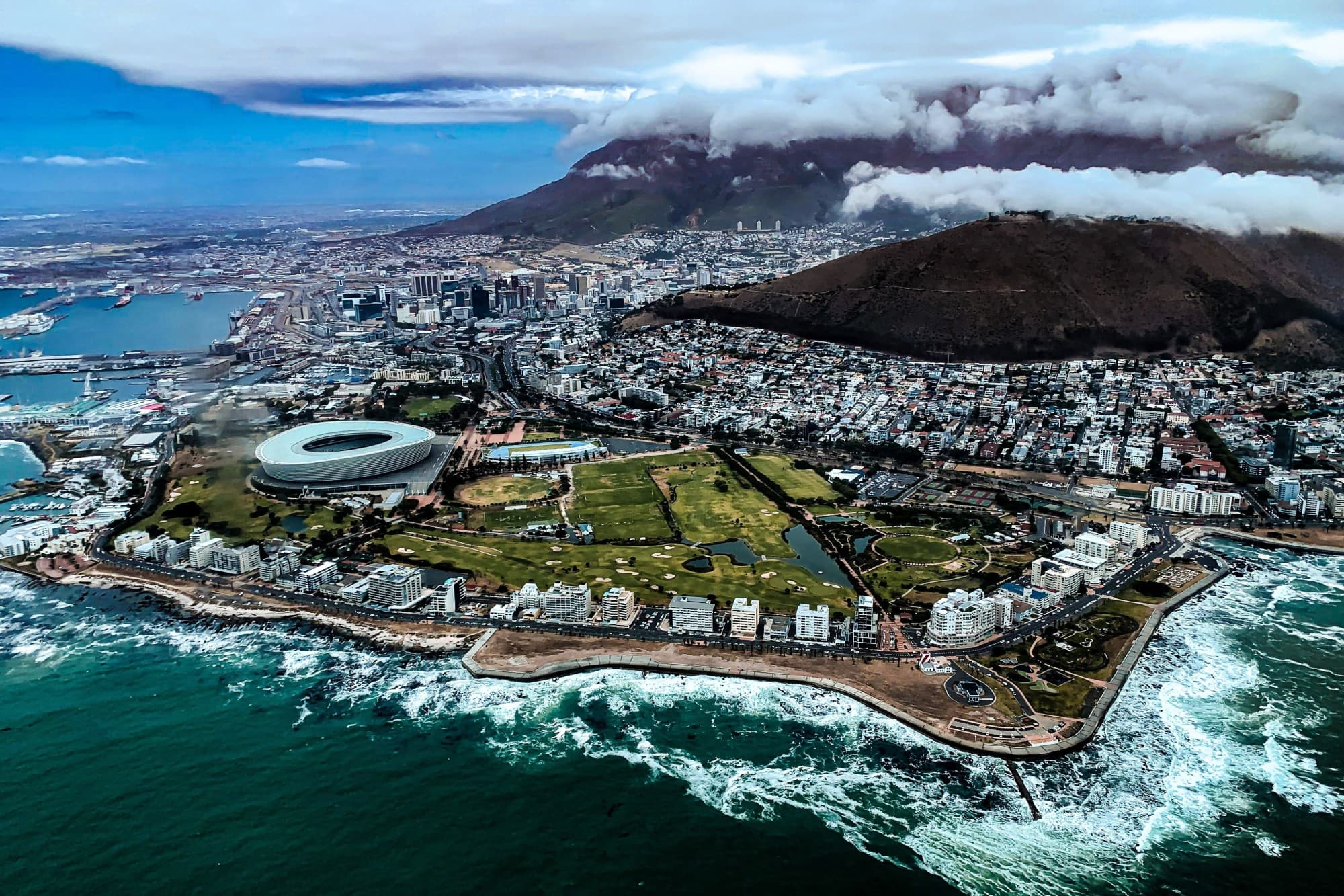 Aerial view of city near body of water during daytime