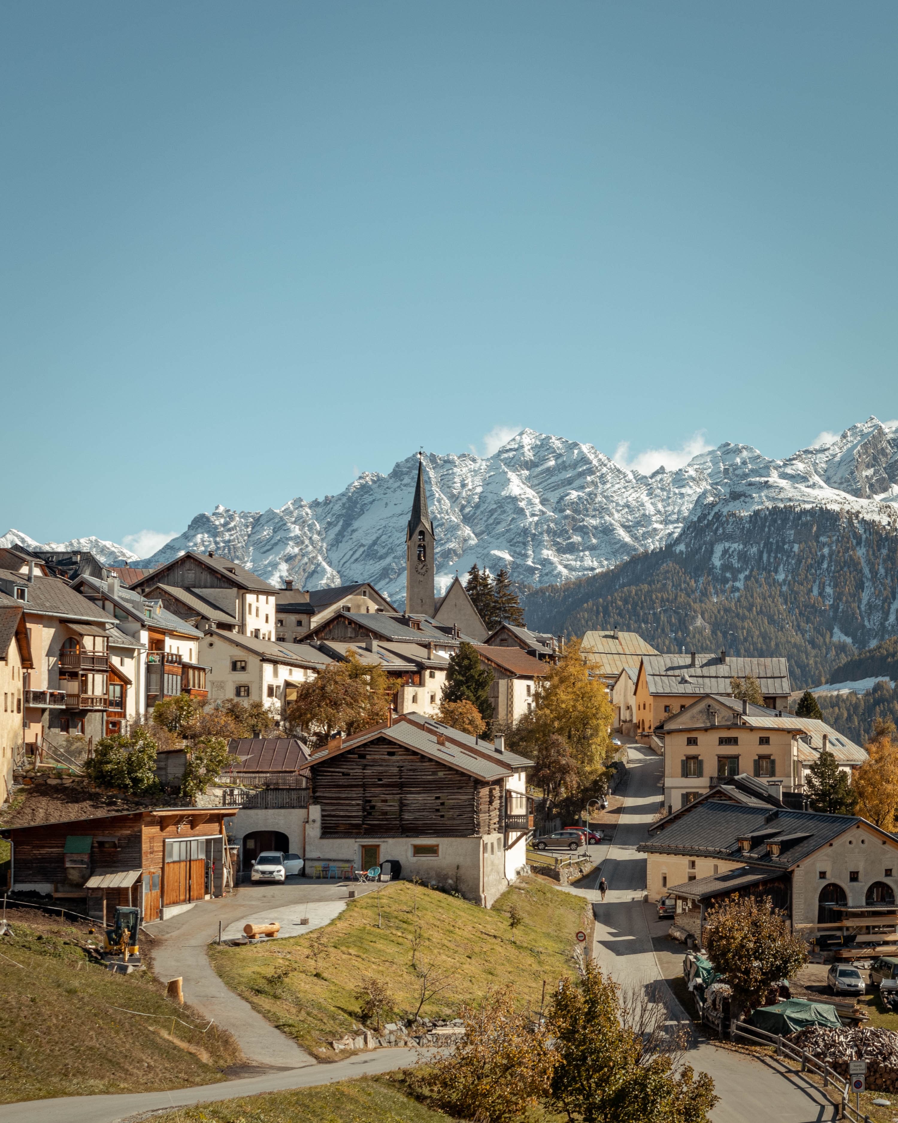 Hut shaped houses with mountains at a distance in background in switzerland