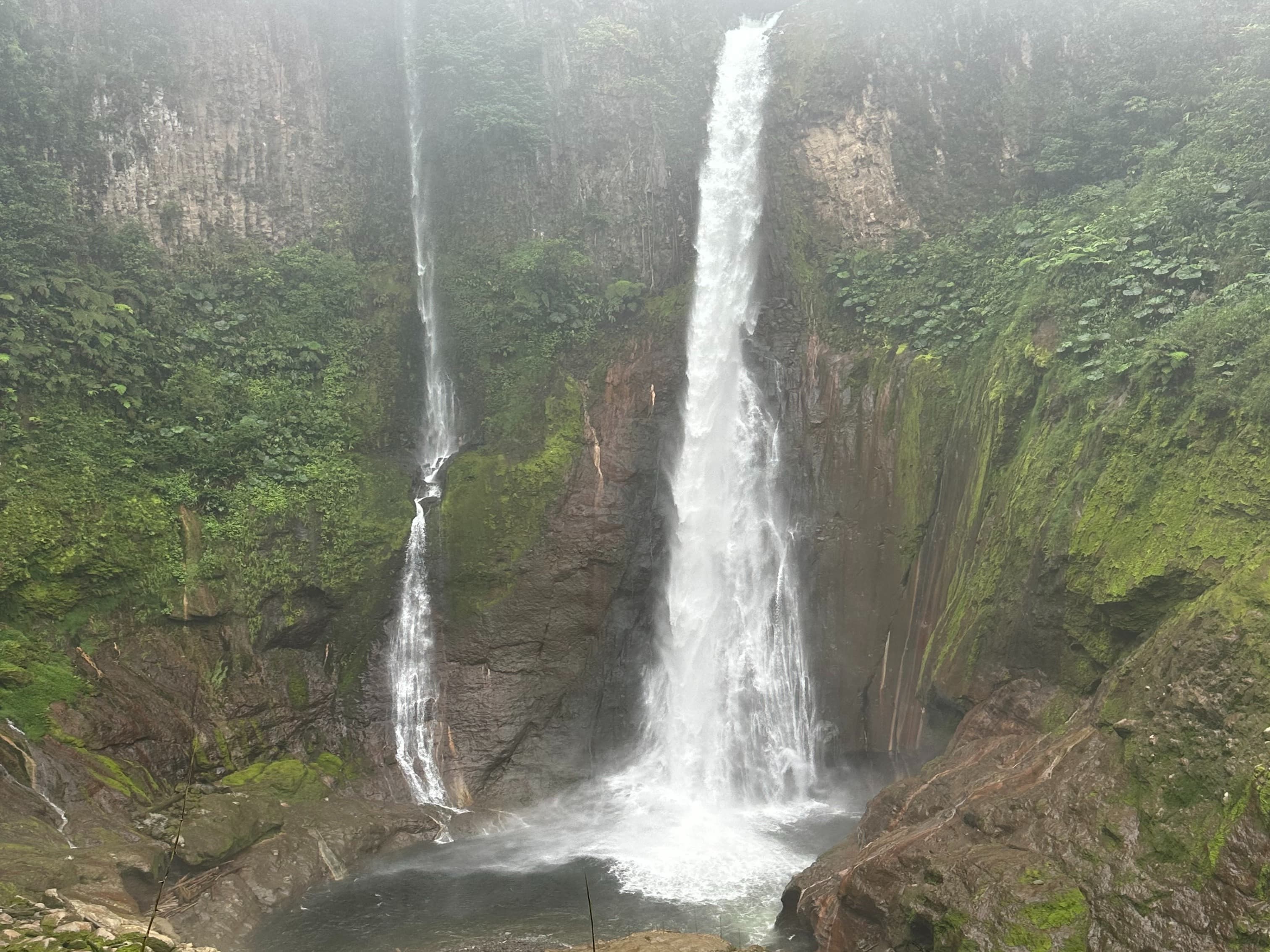 A picture of a waterfall between the mountains during daytime.