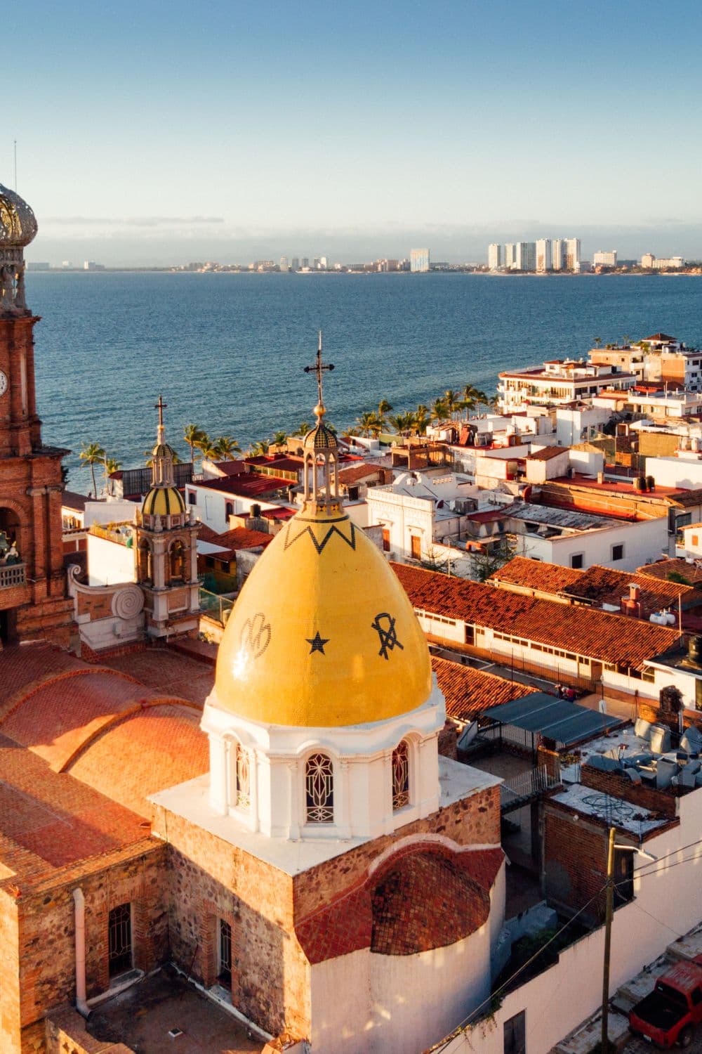 An aerial view of the city with the ocean in the distance.