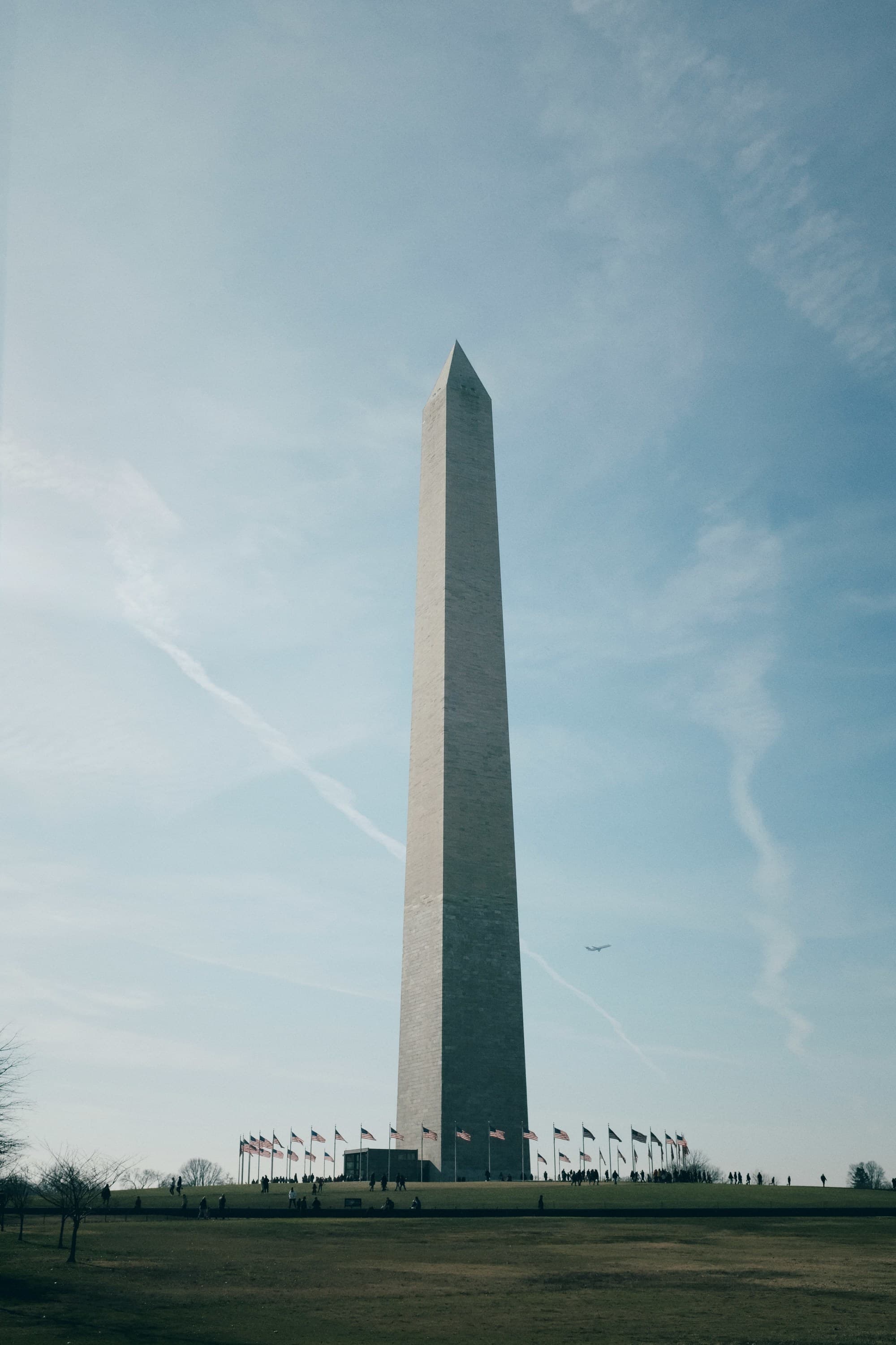 Washington Monument with a plane in the background