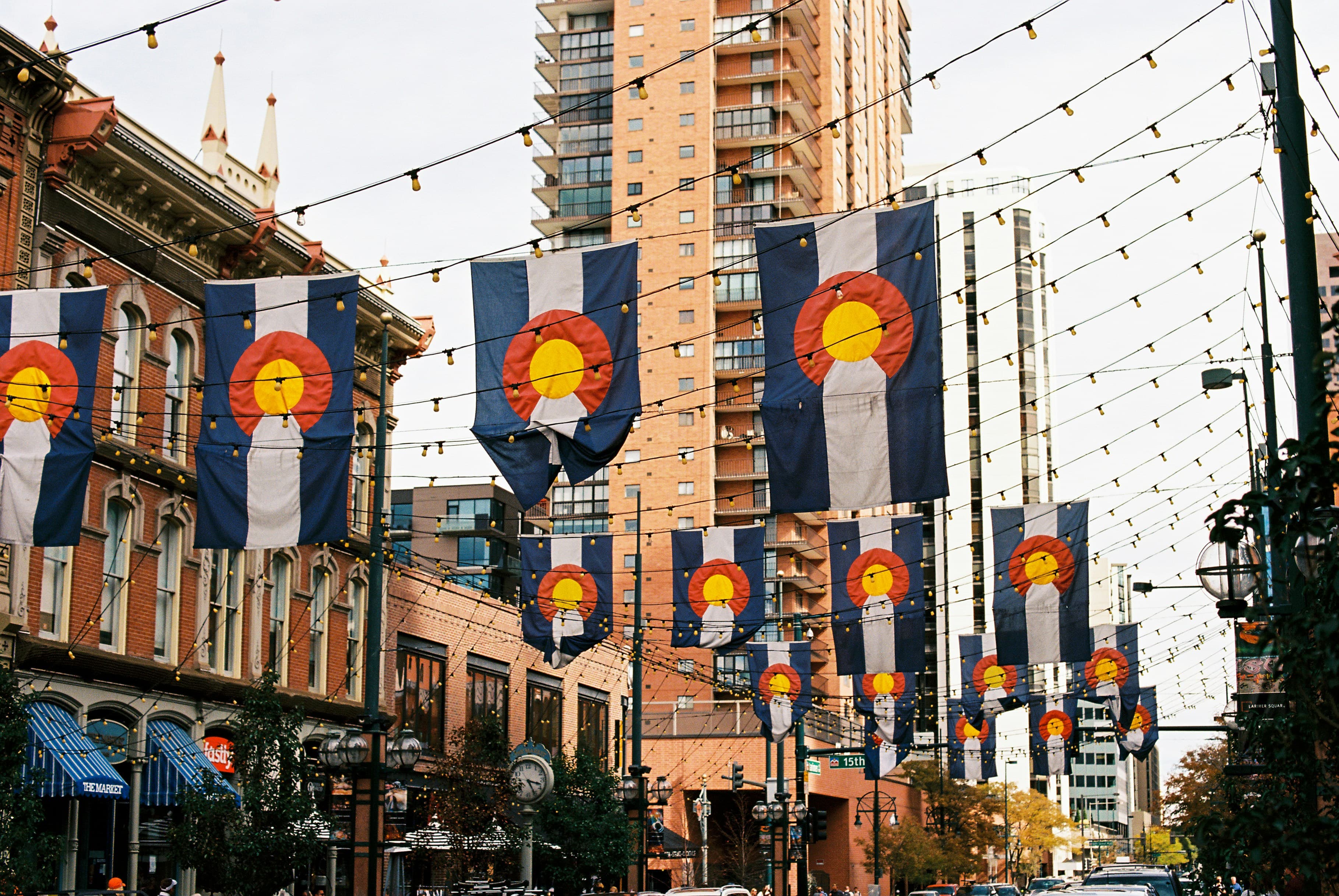 A string of Colorado state flags in a city street