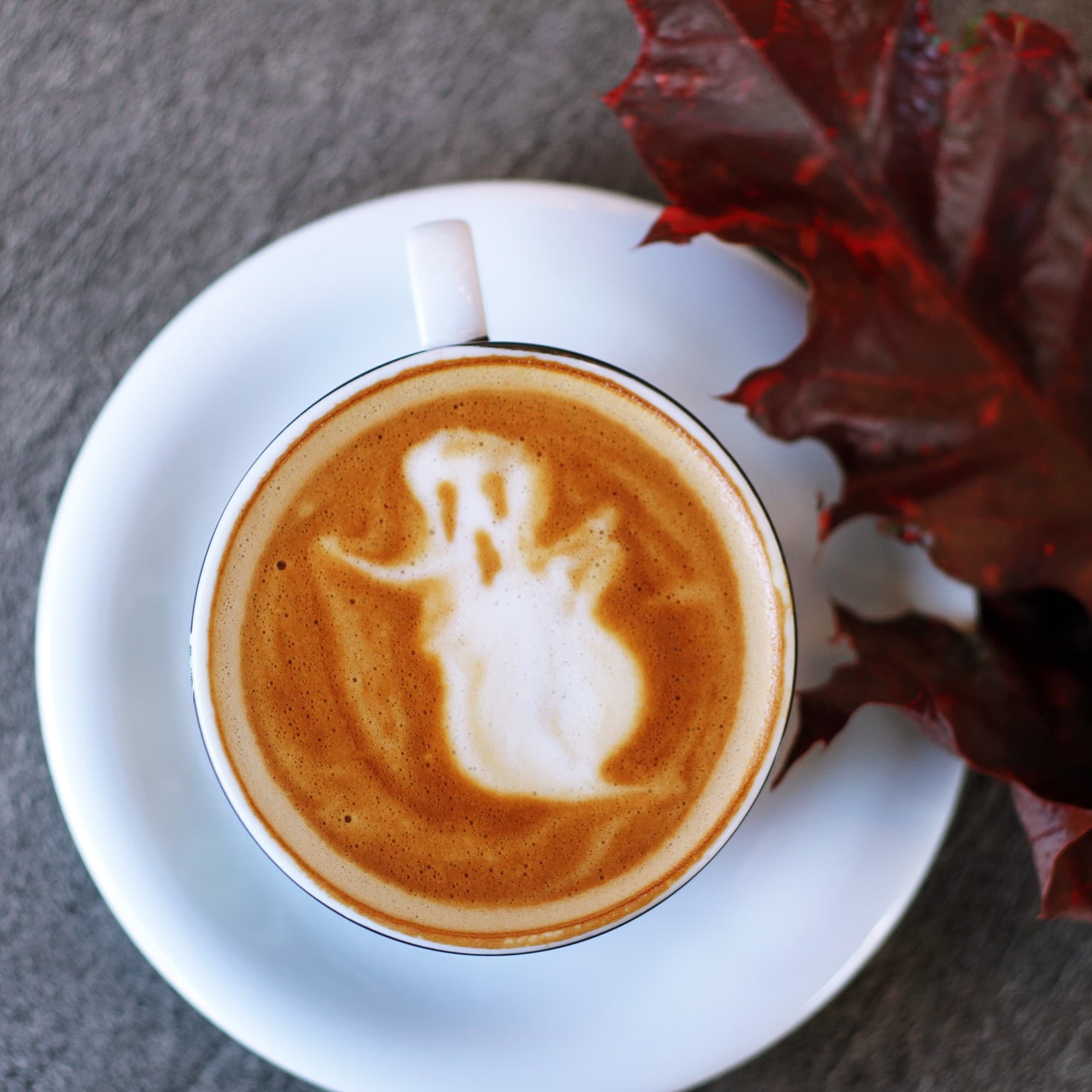 A white coffee cup with ghost pattern.