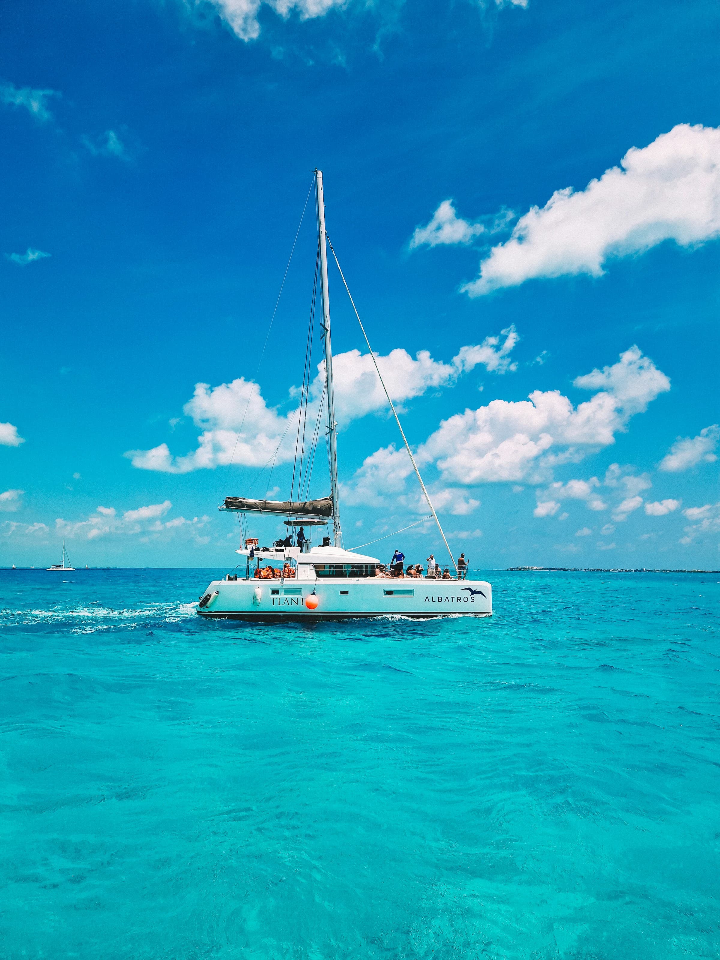 A white boat sailing in a large, blue body of water during the daytime