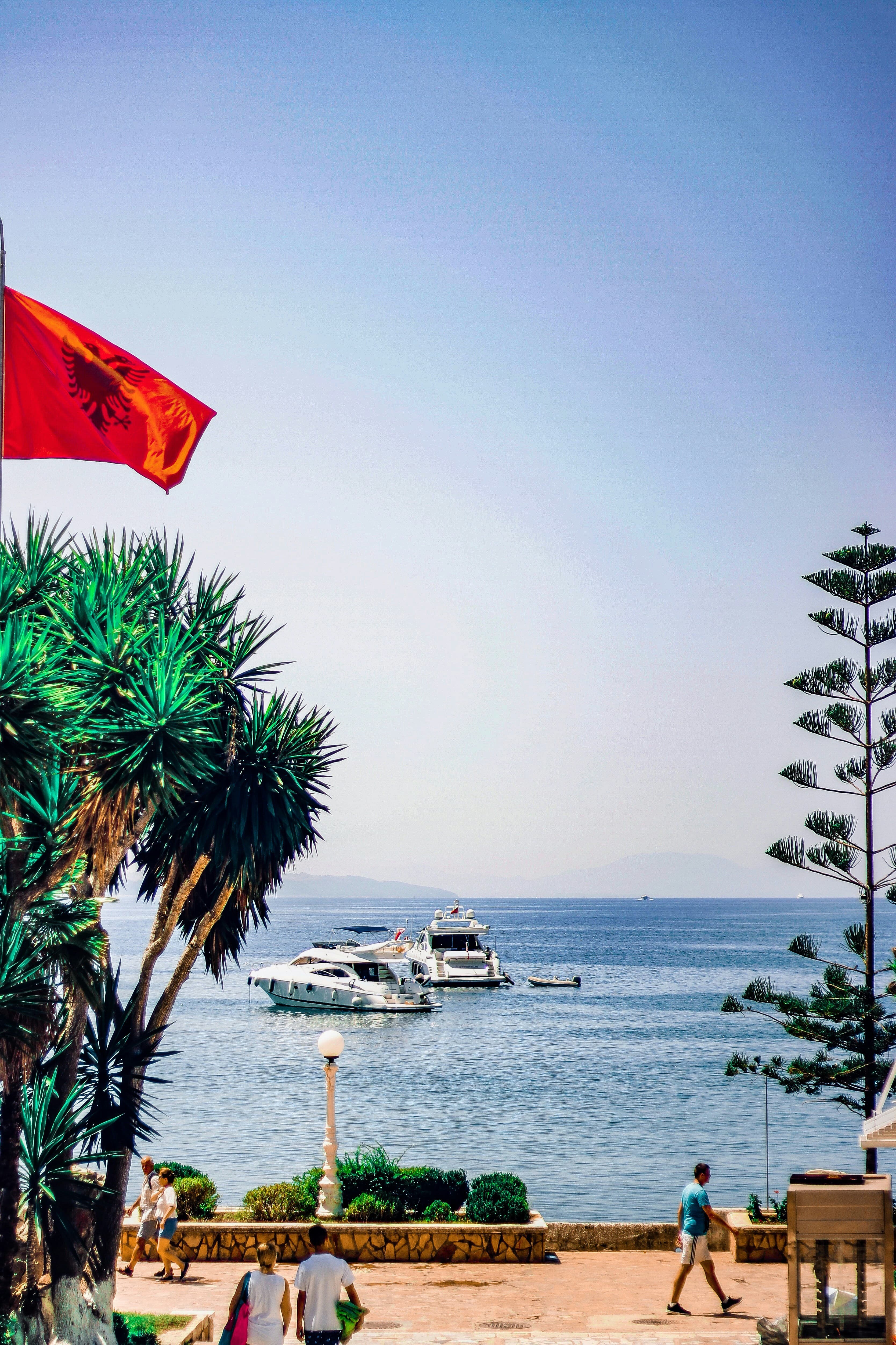 View of the sea at Albania as ships approach the coastline on a clear day.