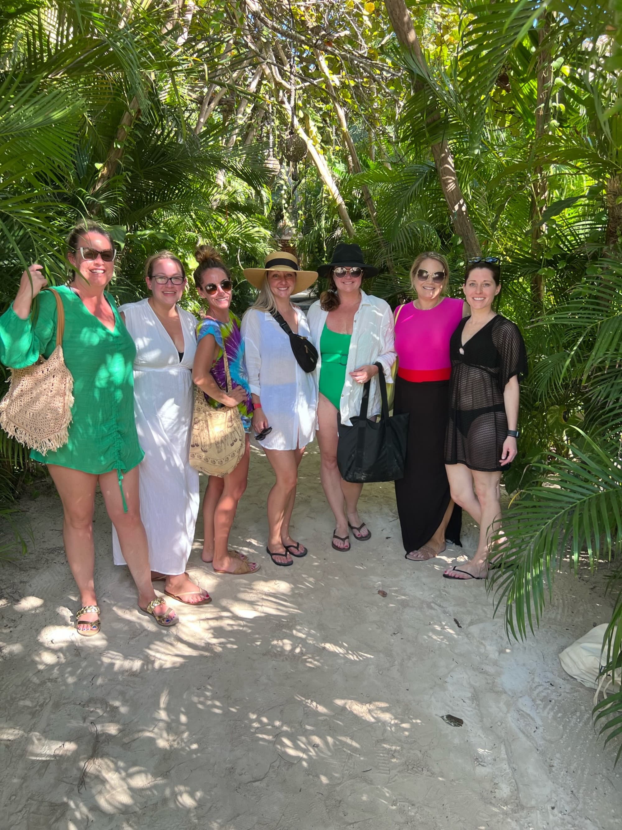 A picture of a group of girls posing at the entrance to Mia.