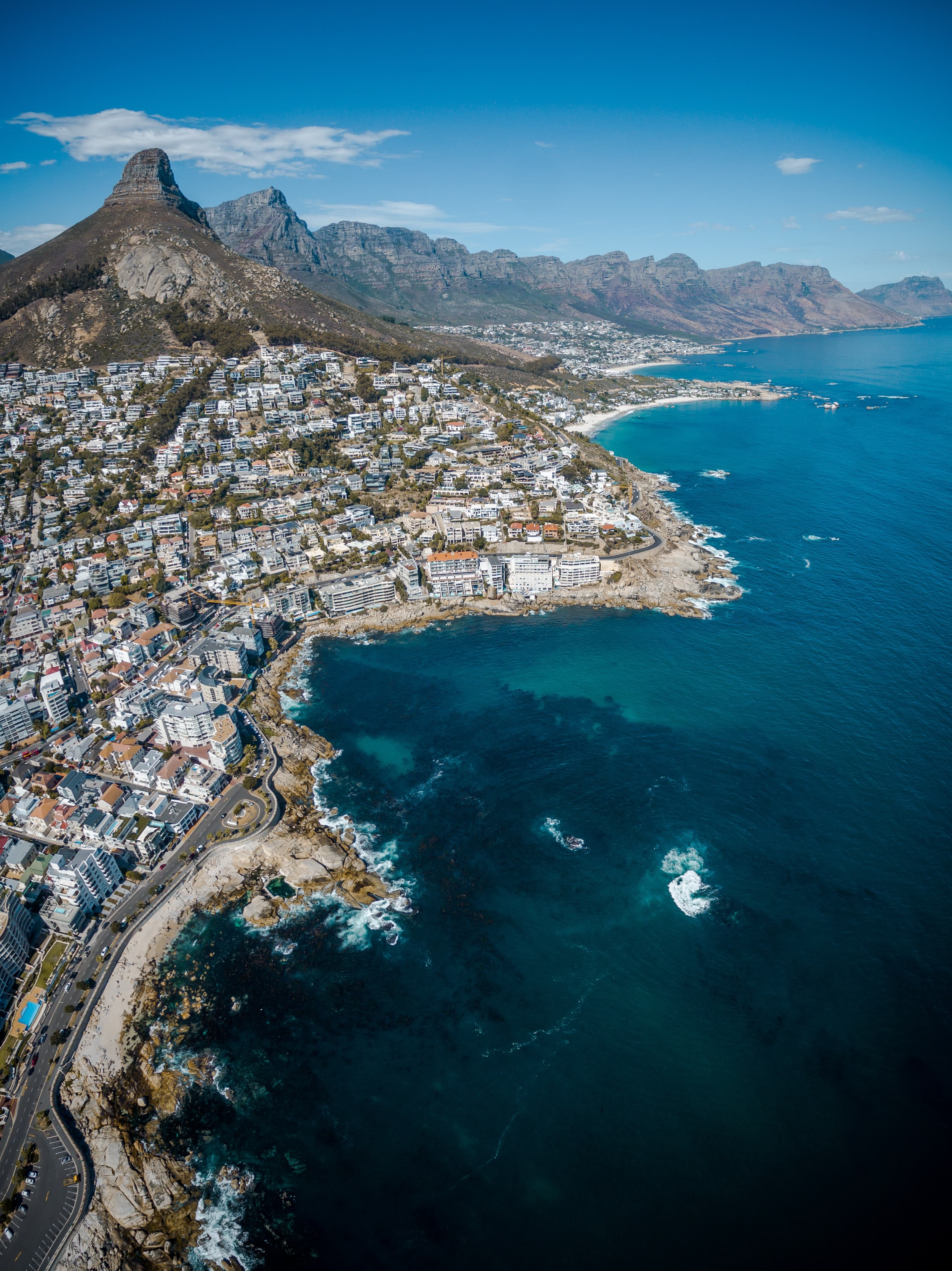 aerial coastal views of city and mountain