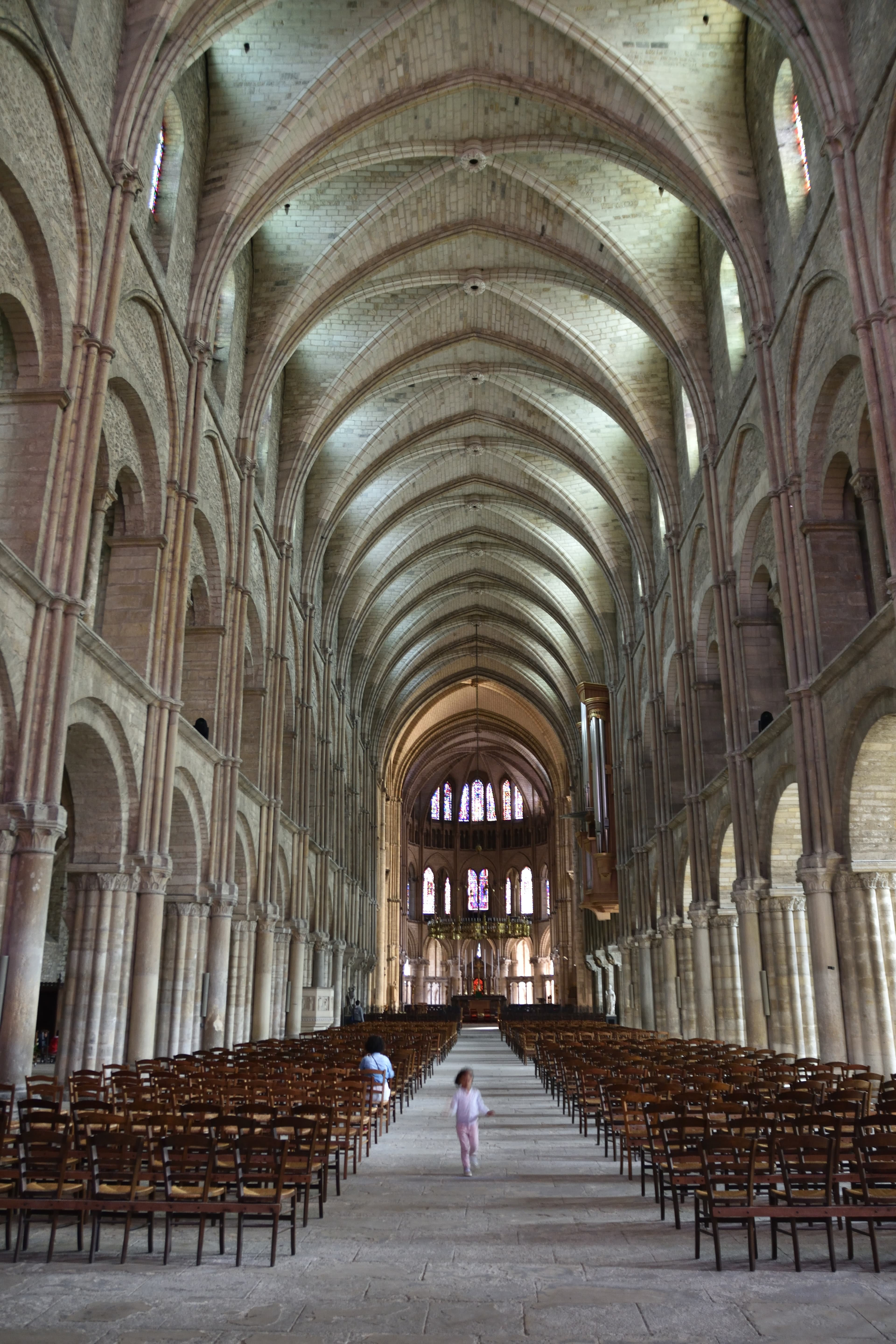 A little girl running through the cathedral in Reims, France.