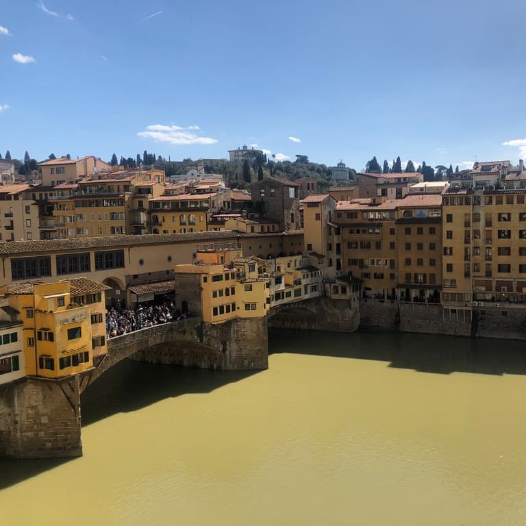 Yellow and brown buildings with city lake on a sunny day.