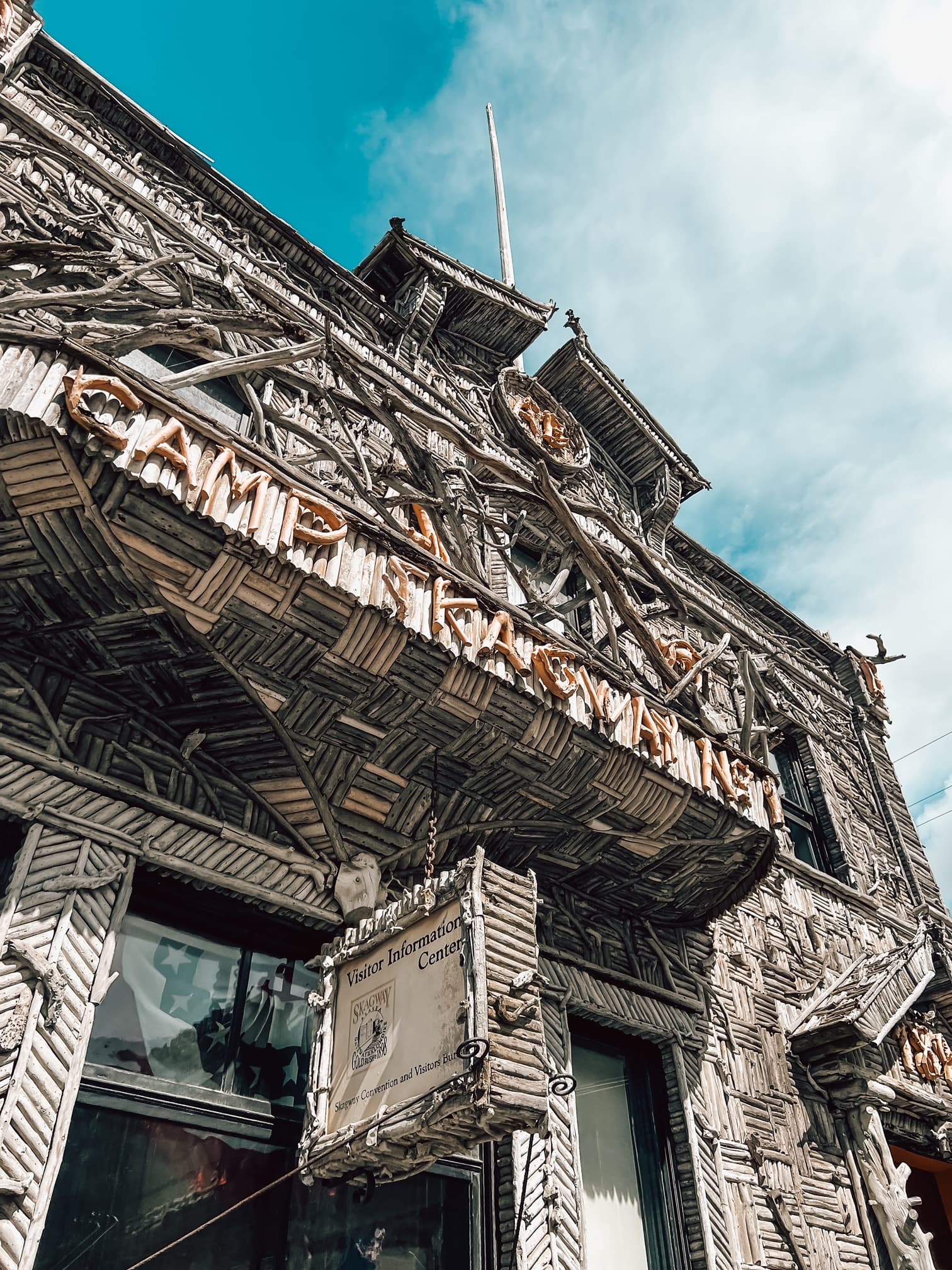 Skagway boasts wooden buildings that stand tall against a blue sky dotted with clouds.