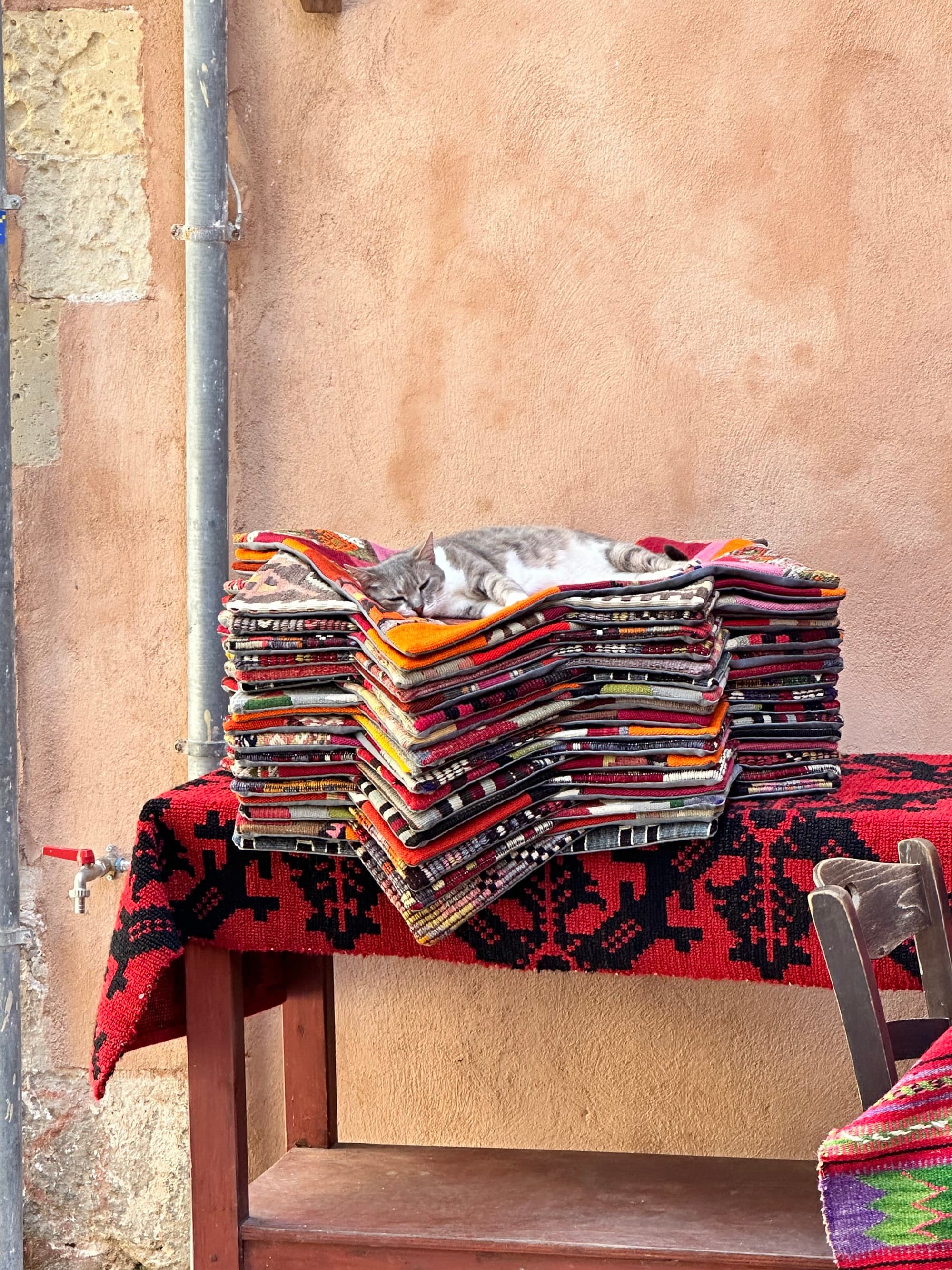 Stack of clothing arranged on a table.