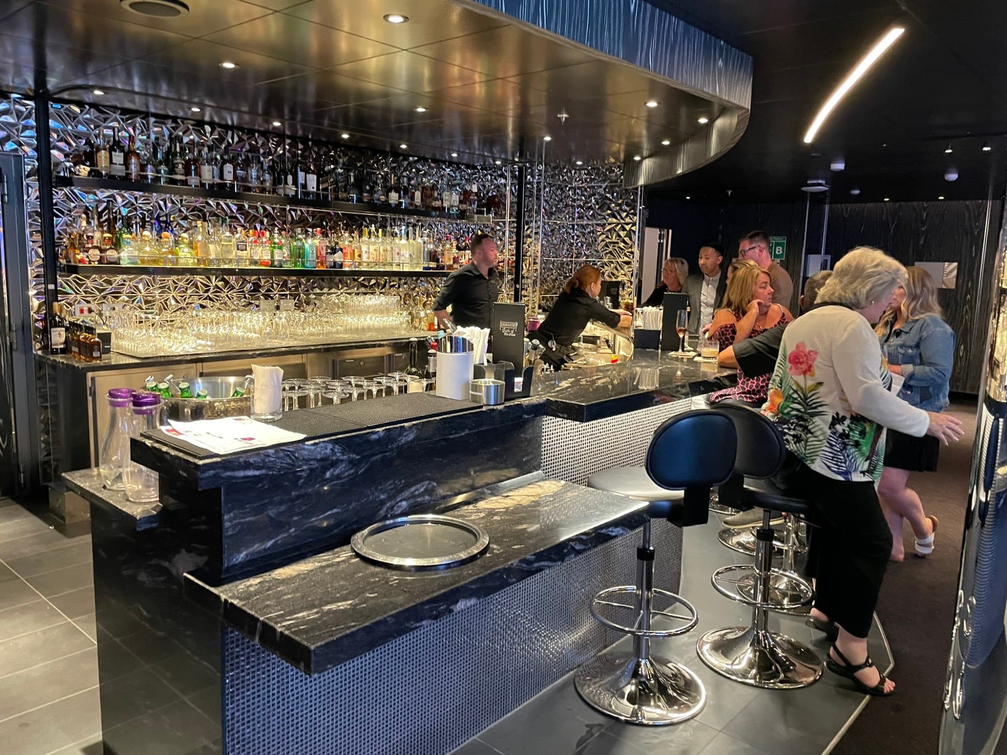 A casino bar with passengers milling around.