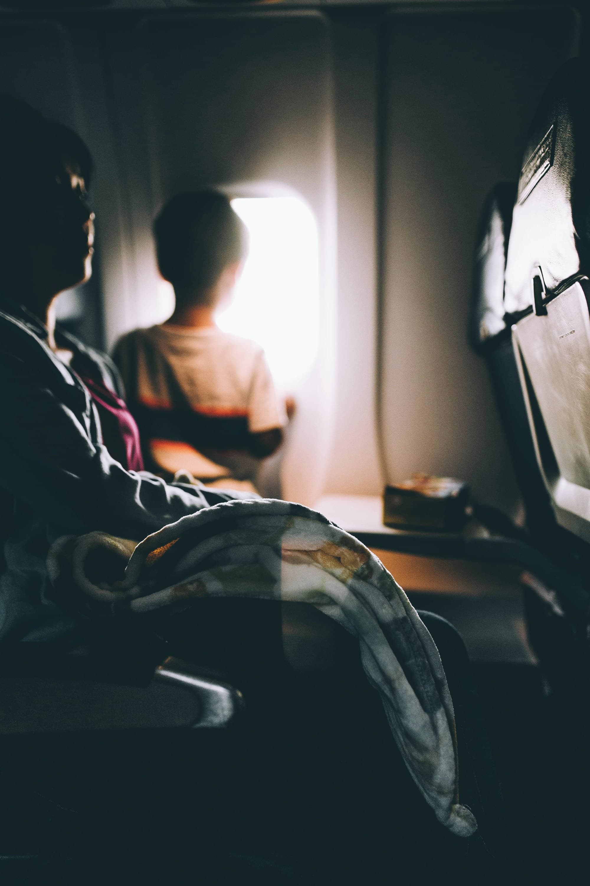 A child looking out of an airplane window