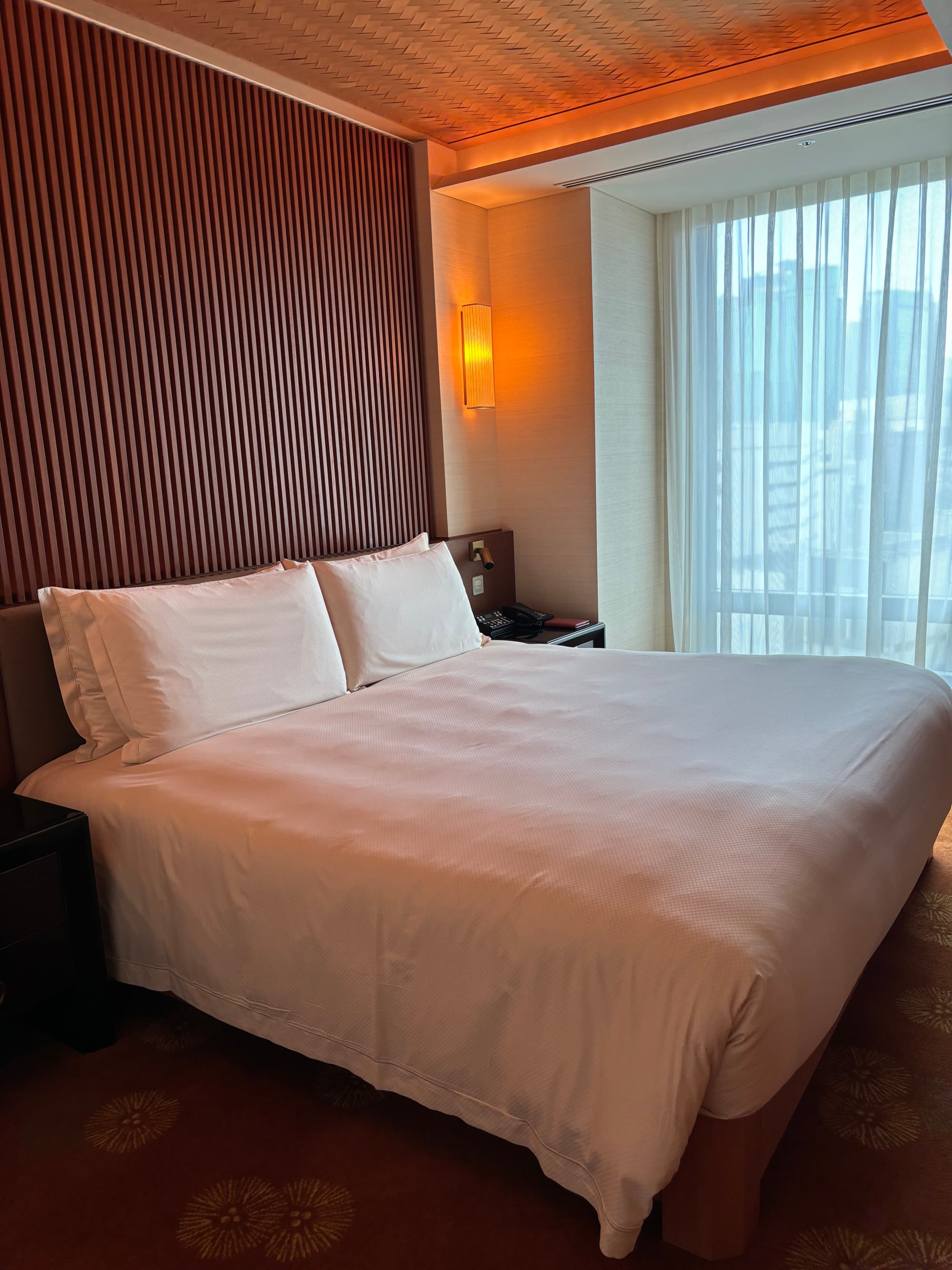 A large white bed in a hotel room