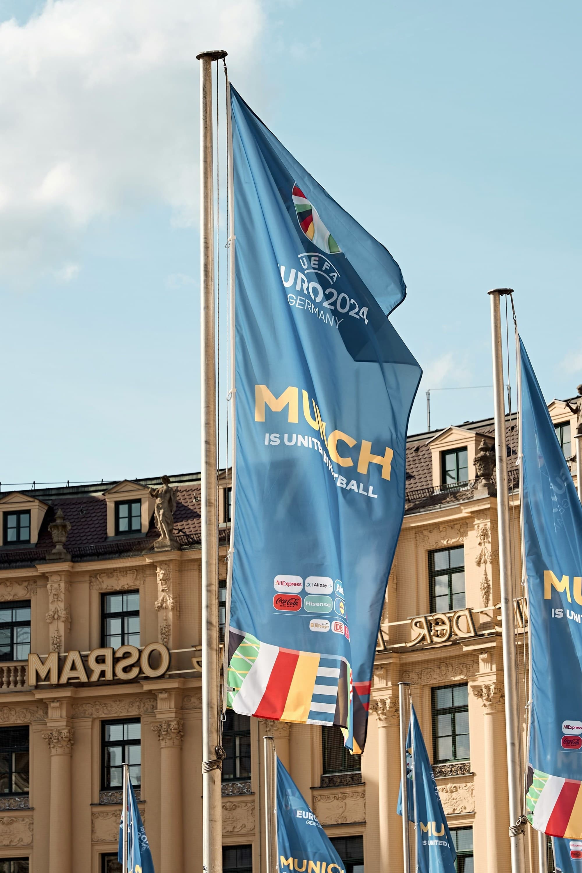 A bunch of flags in front of a building.