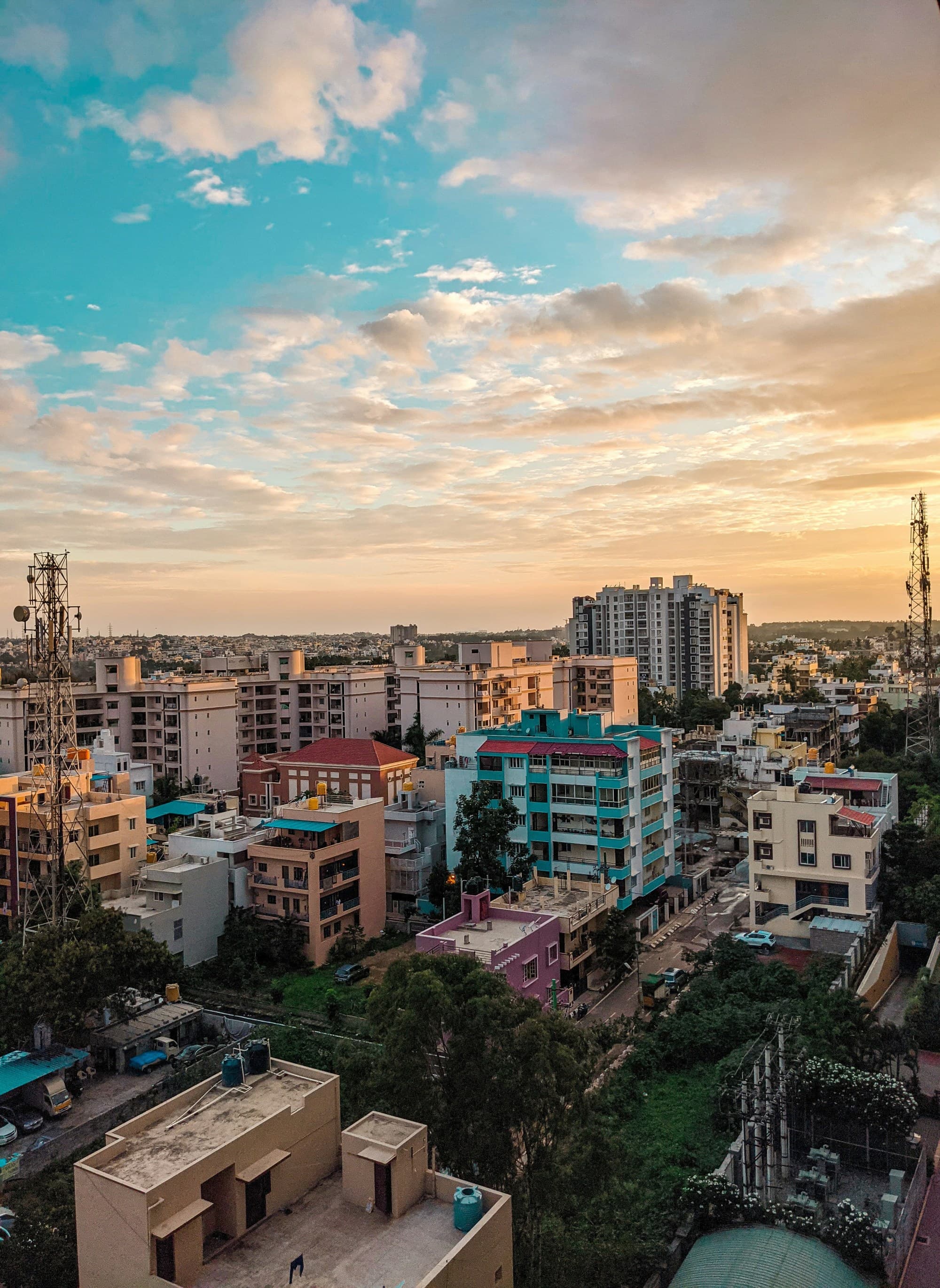 A picturesque sunset cityscape with diverse building silhouettes.