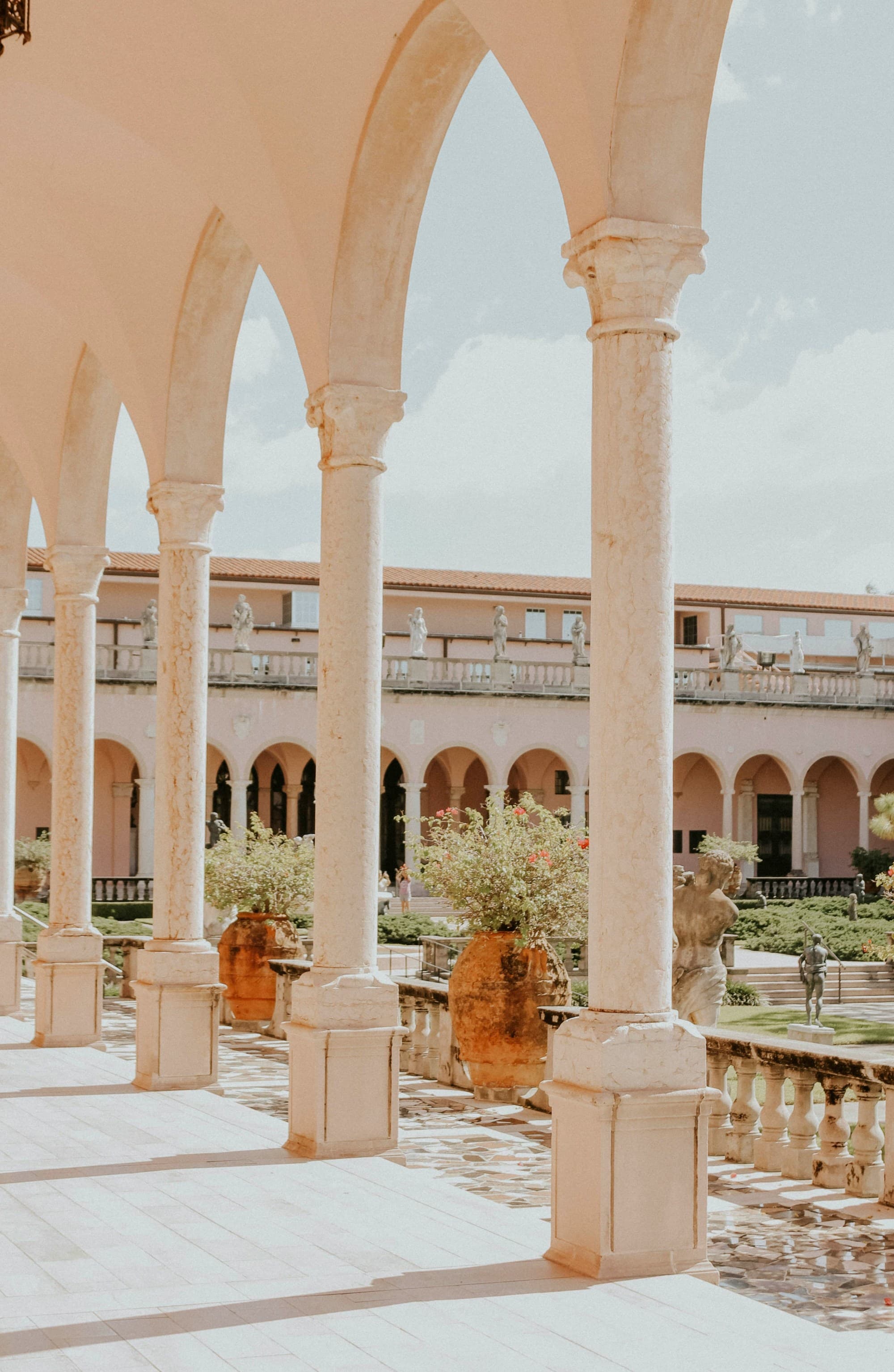 A white building with arches and an interior garden