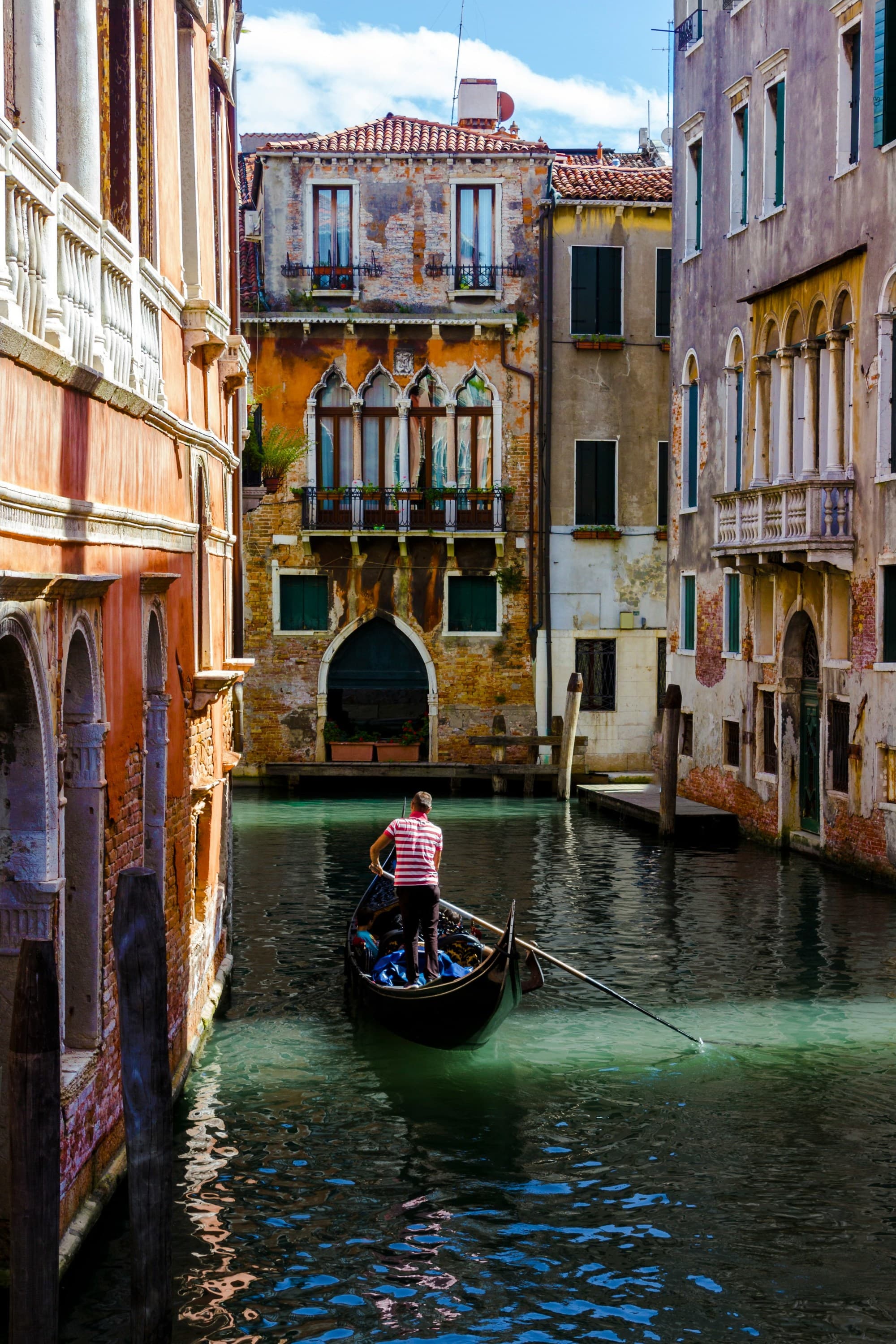 A boat ride in a canal between buildings