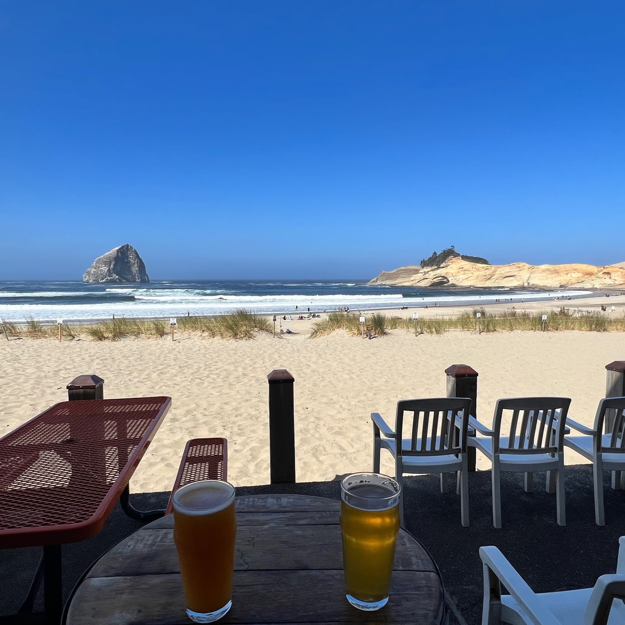 Beer at outdoor sitting of a restaurant with beach view.