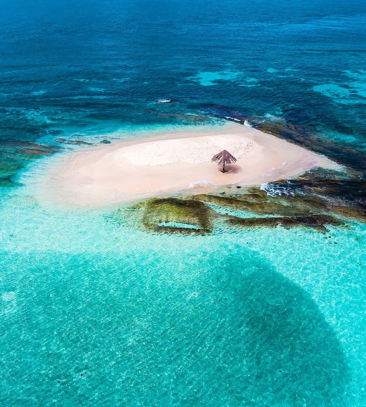 Blue water surrounds Mopion Island, Saint Vincent and the Grenadines.