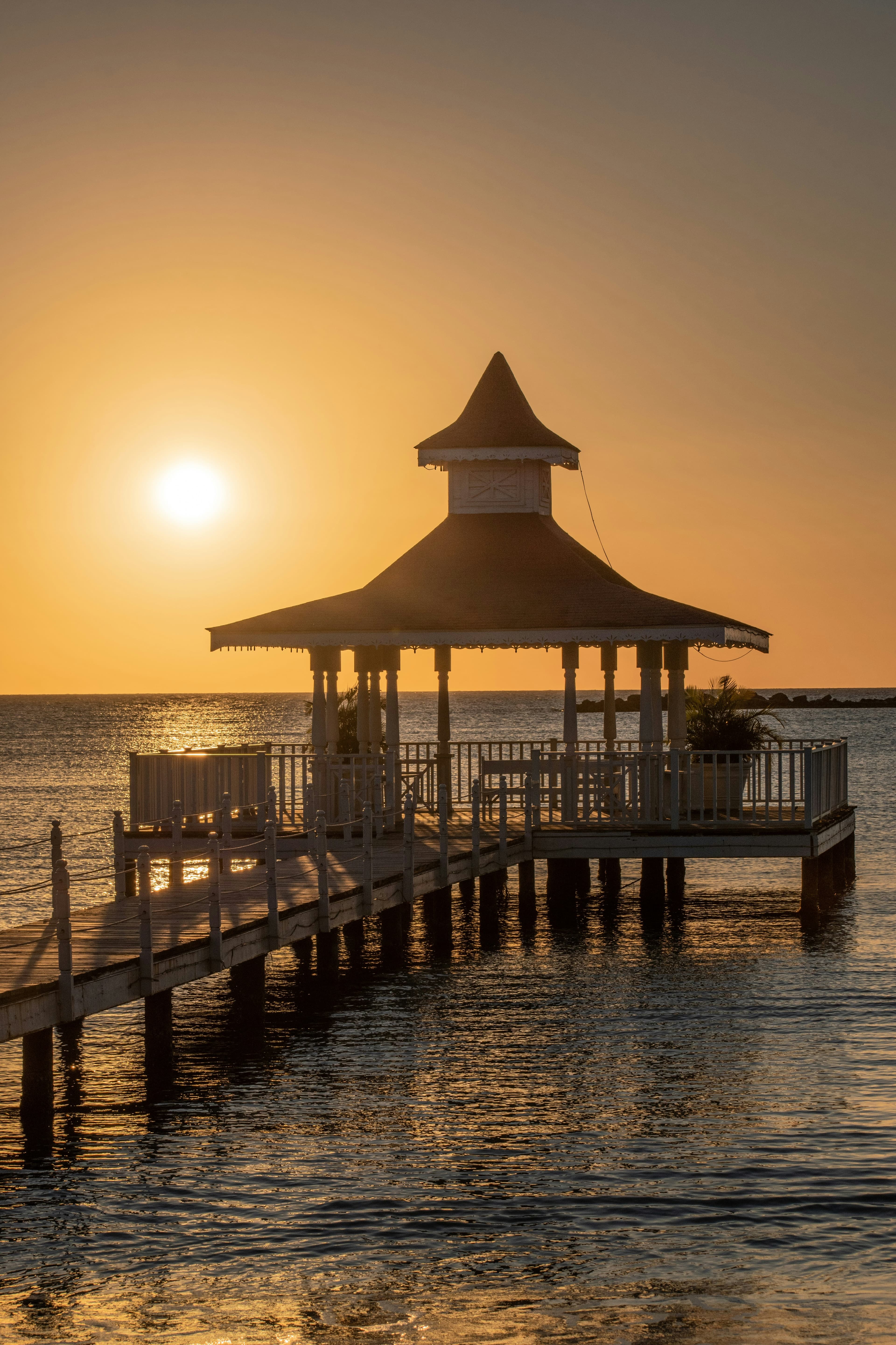 A pier over the water during a sunset