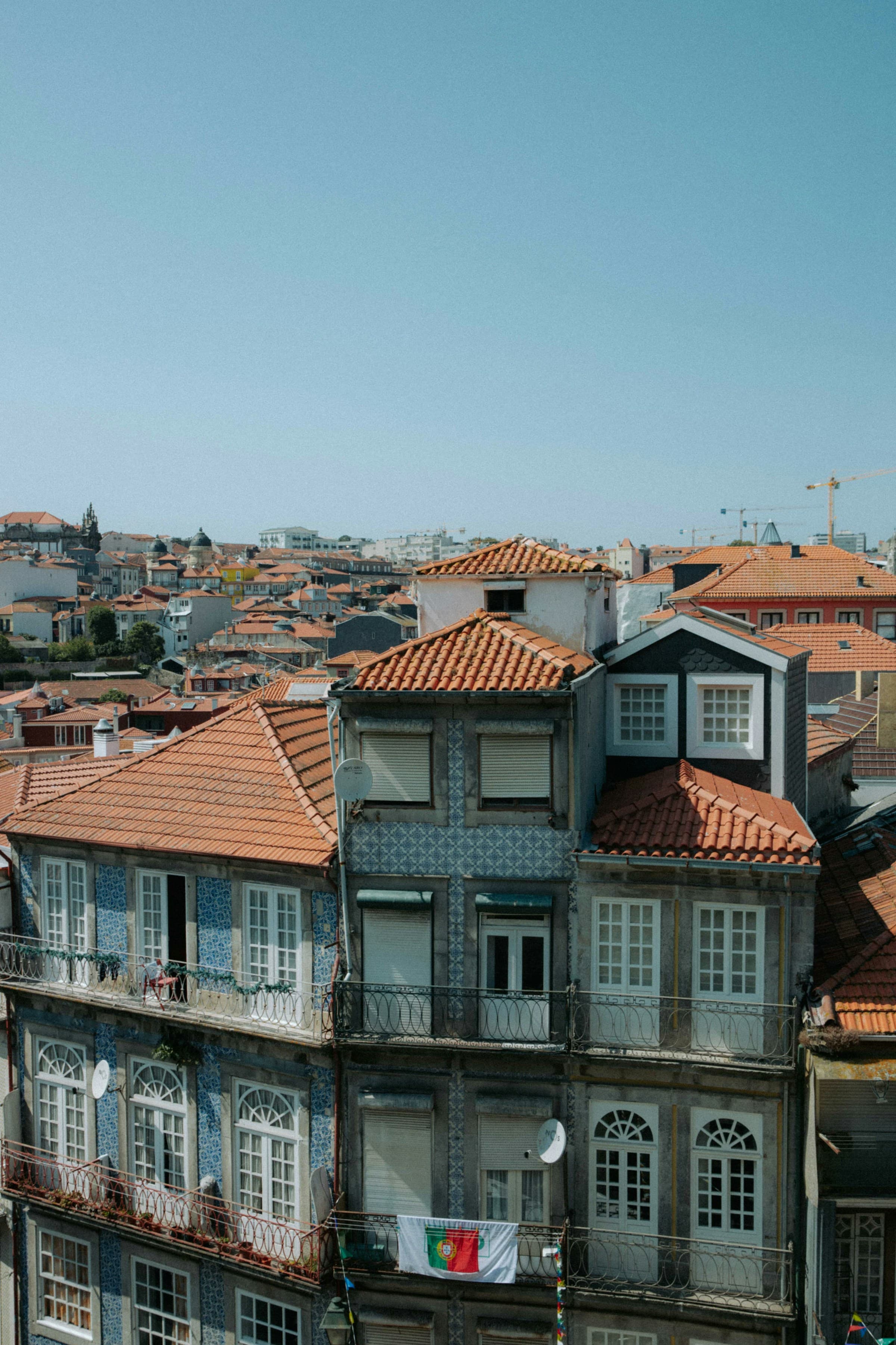 A local residential building with red roofs in Portugal on a sunny day.