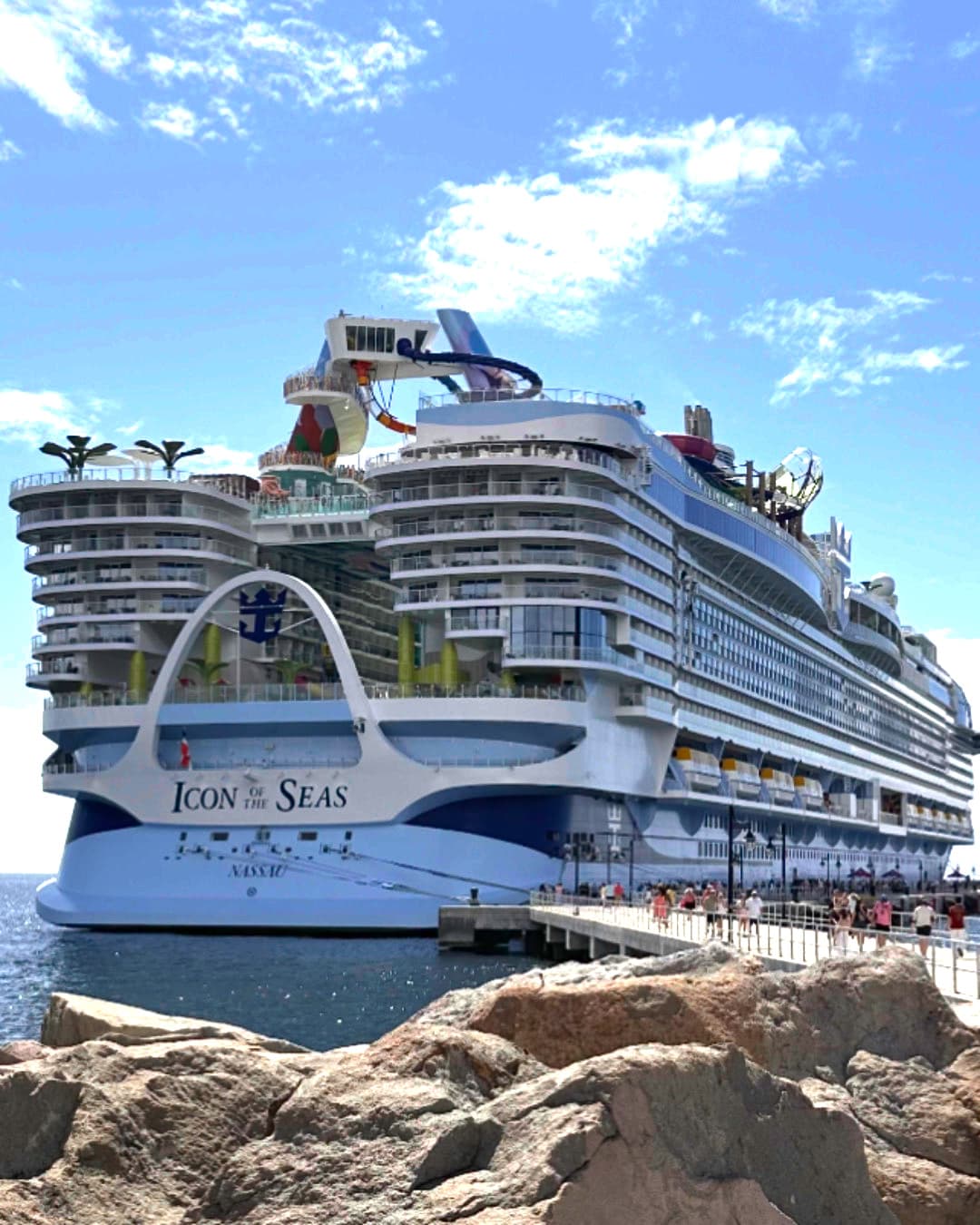 A cruise ship with the name Icon Of The Seas on the ocean.