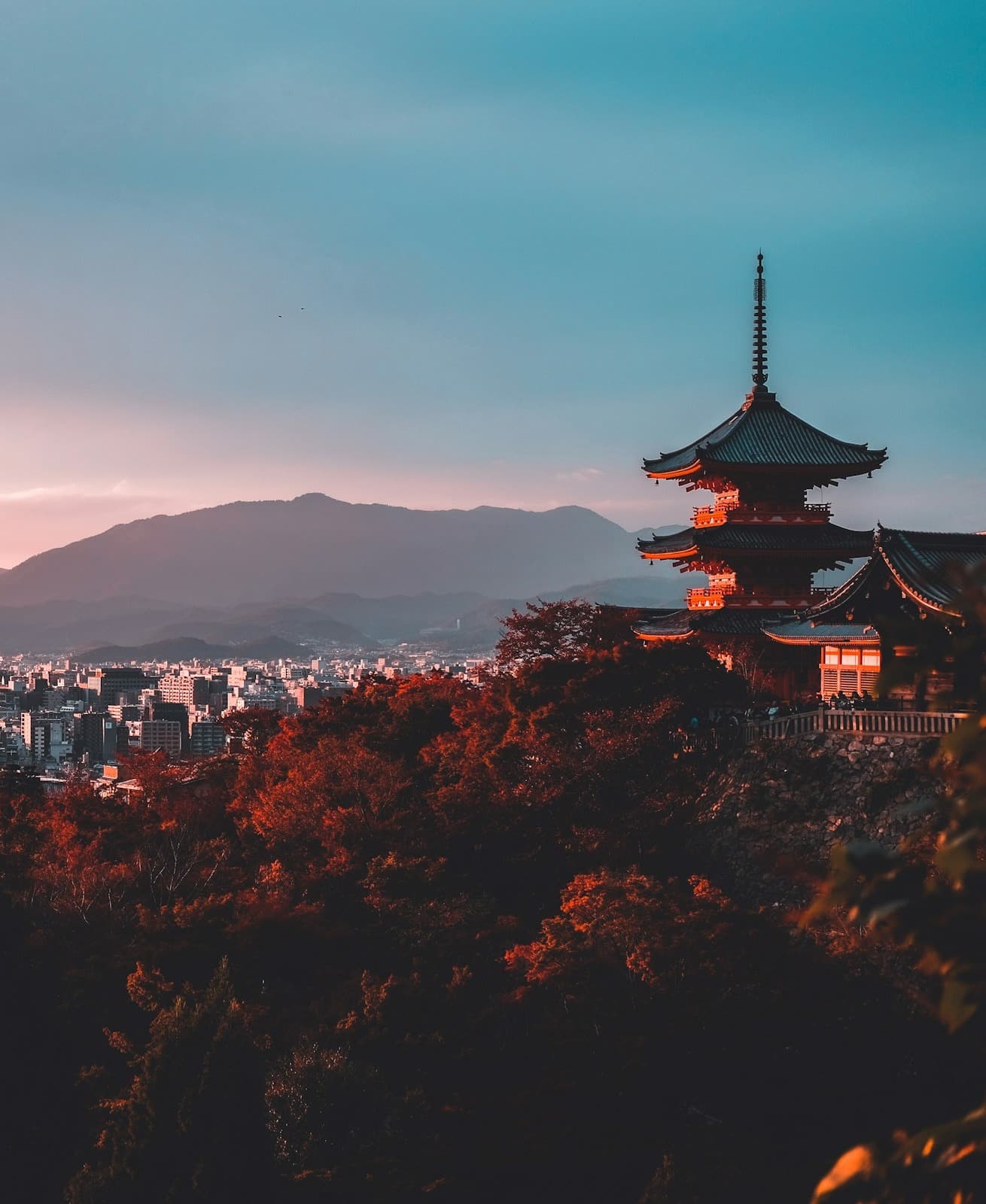 Pagoda surrounded by trees during a sunset