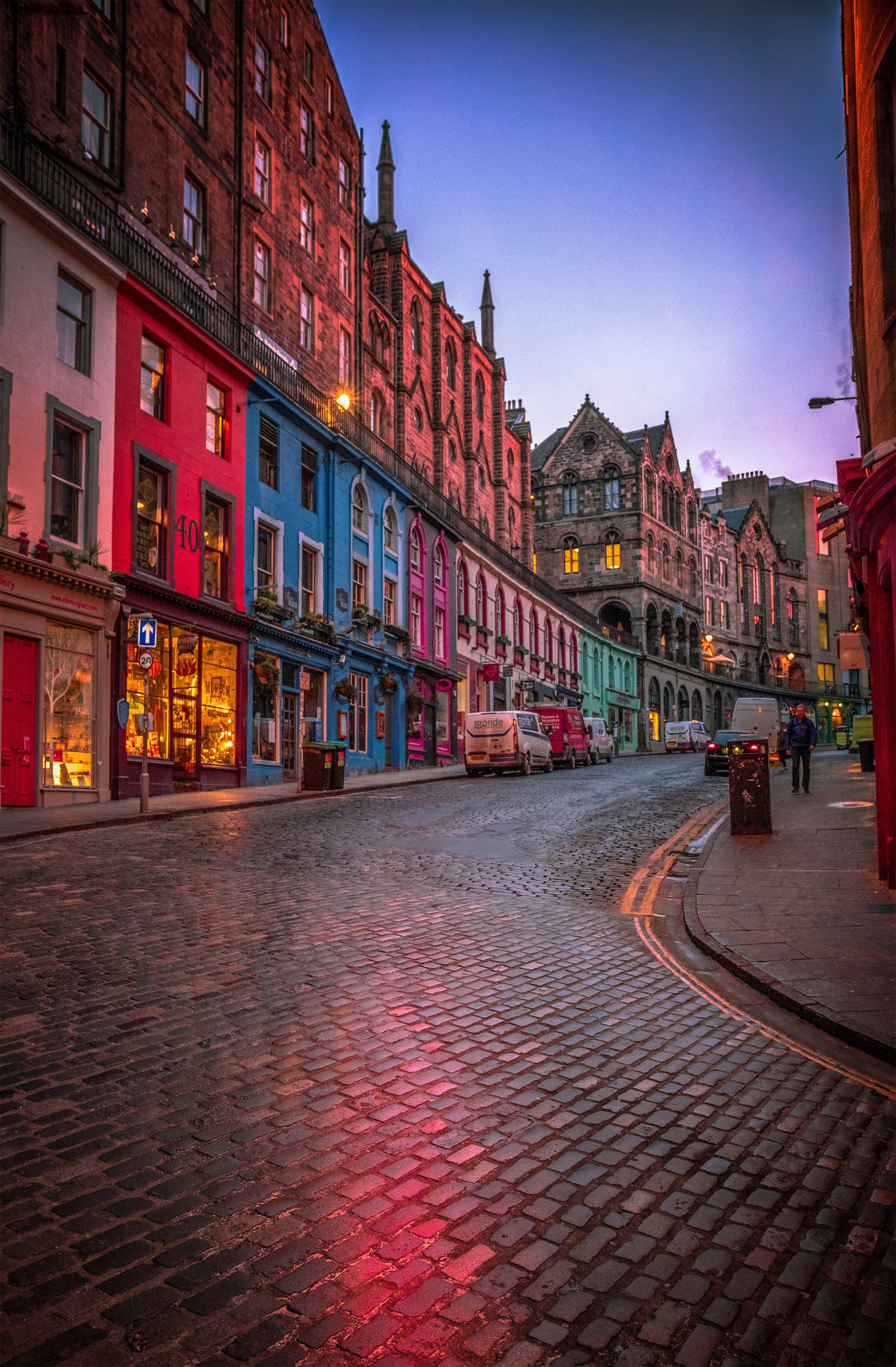 Colorful buildings on a cobblestone street during nighttime