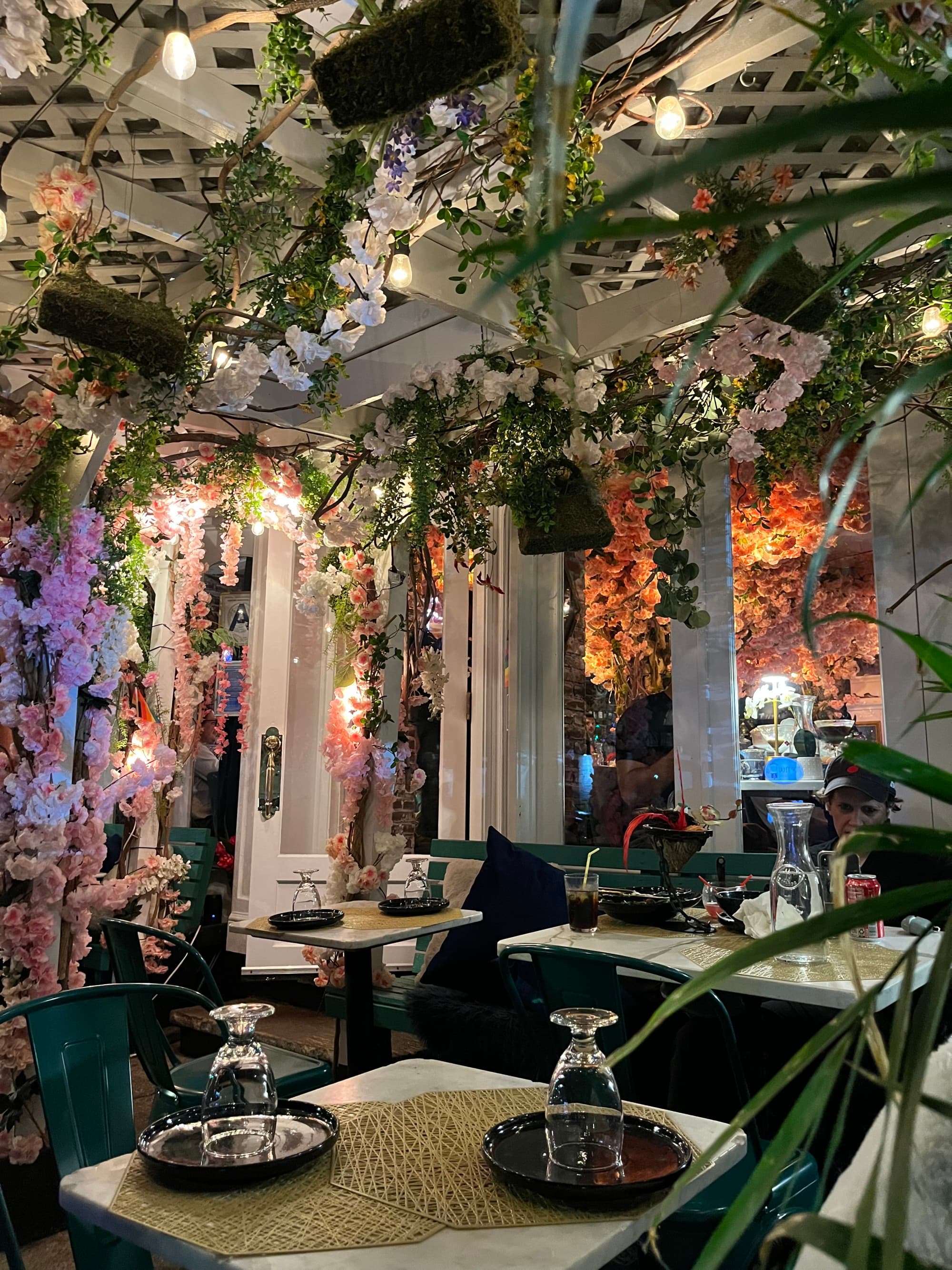 The interior of a restaurant with colorful floral decorations.