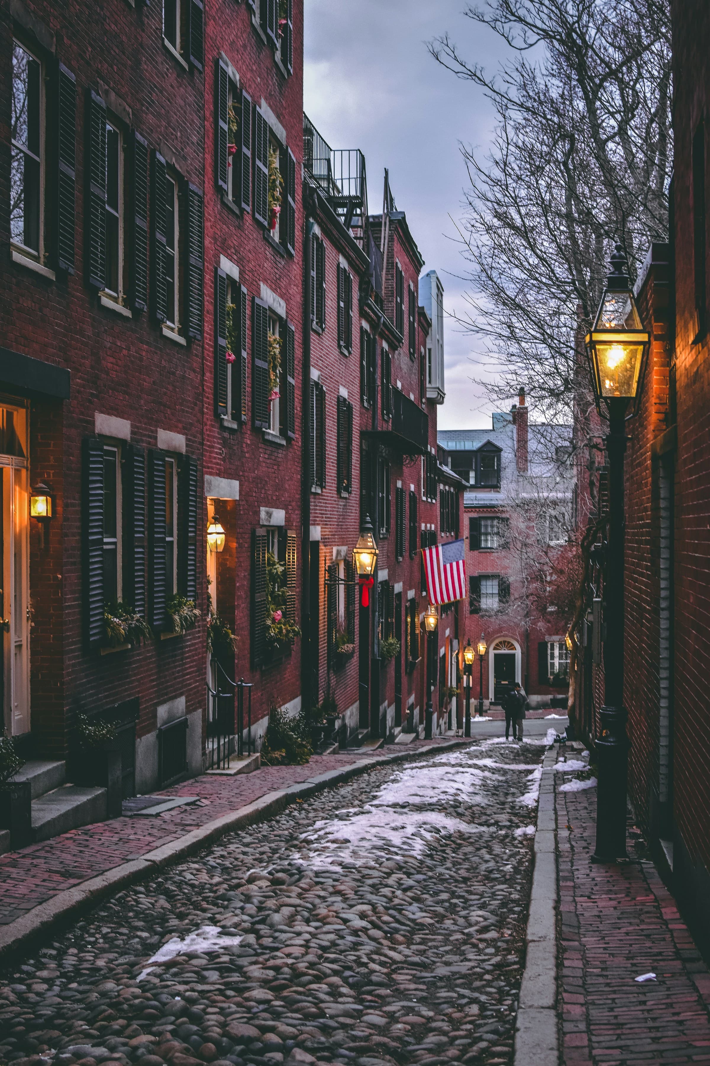 A narrow street with red brick homes on each side